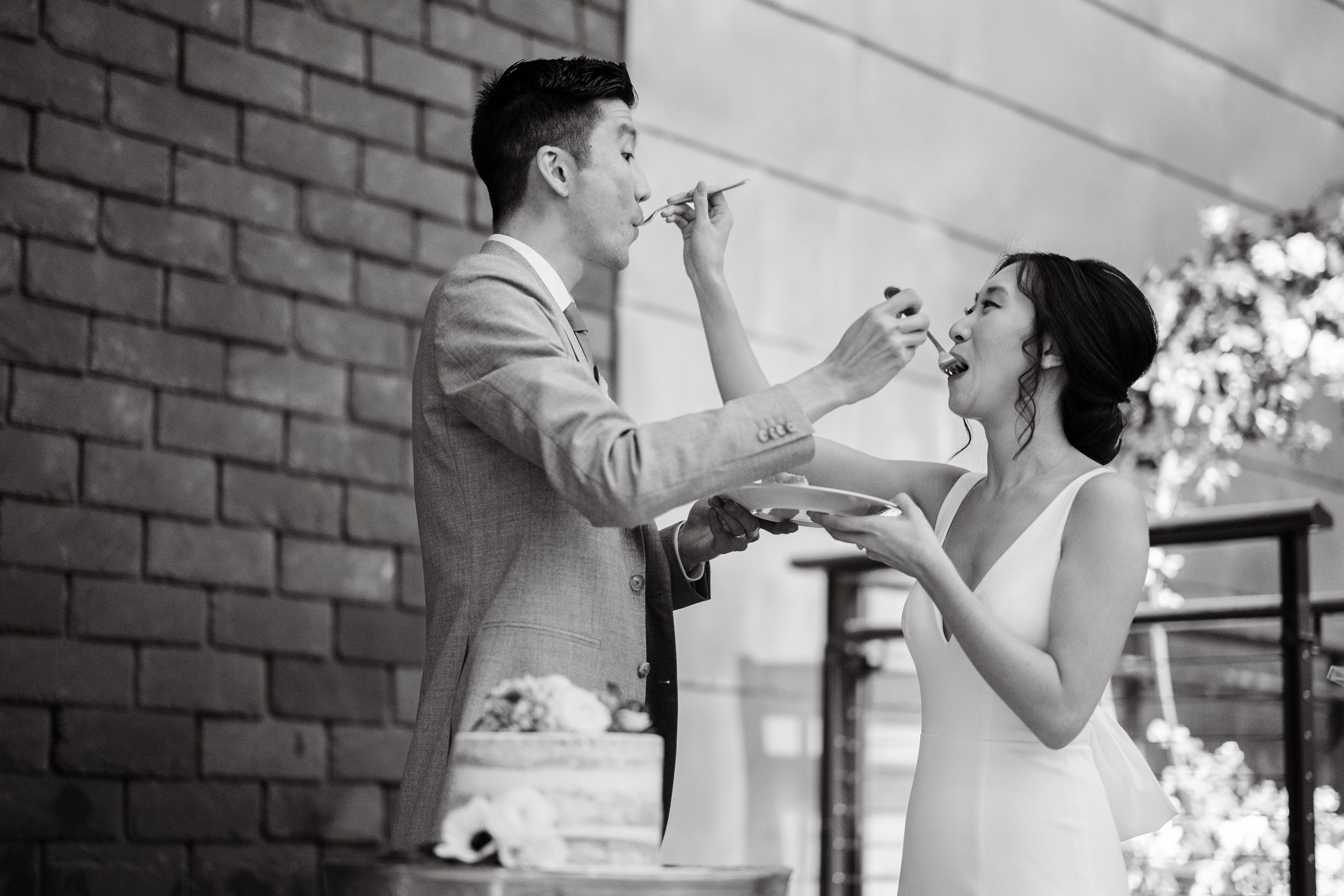 Bride and Groom Taste Cake Wedding at Bay 7 Durham NC Fancy This Photography