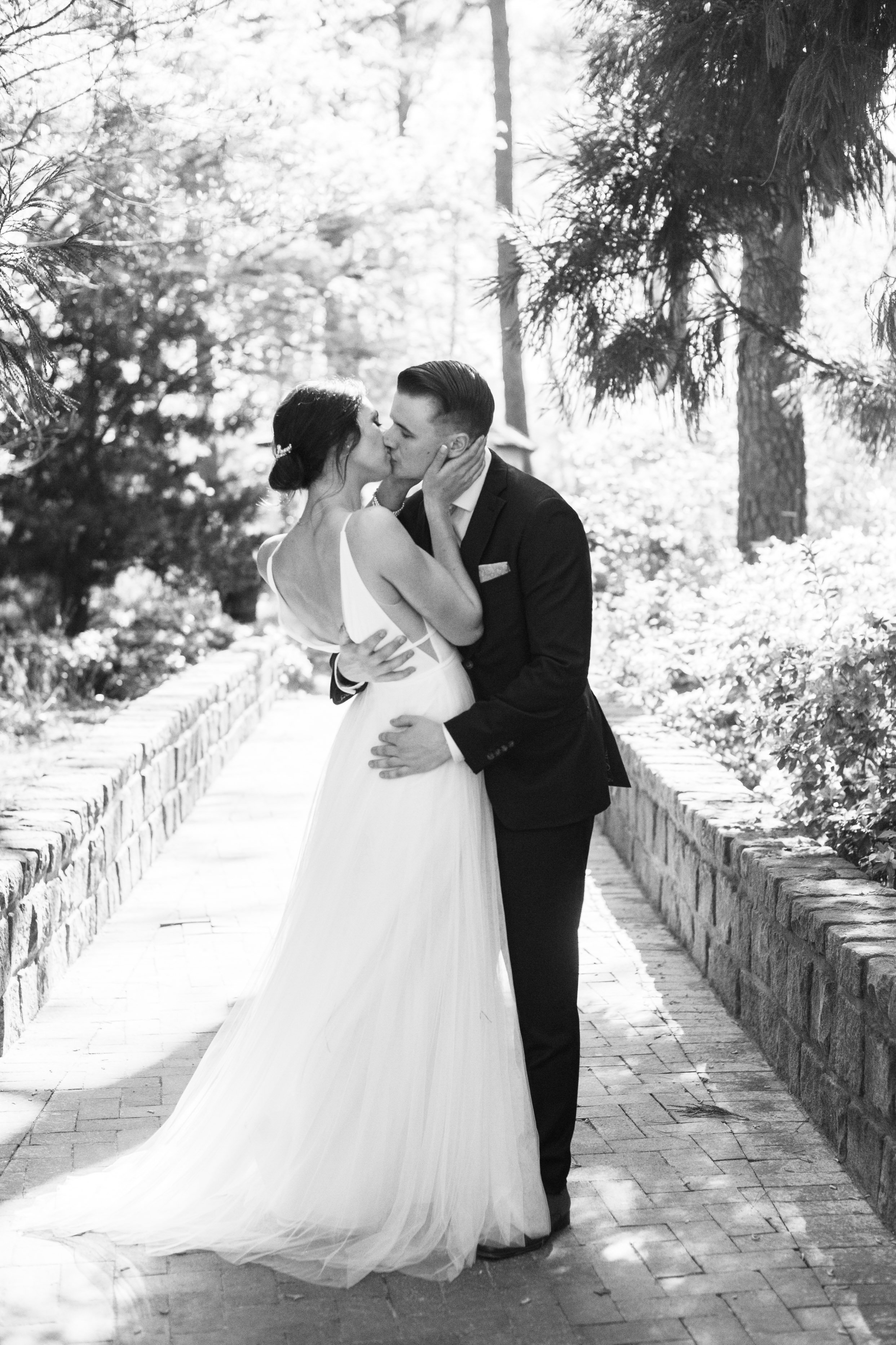 Pathway Kiss Bride and Groom in Cape Fear Botanical Garden Wedding
