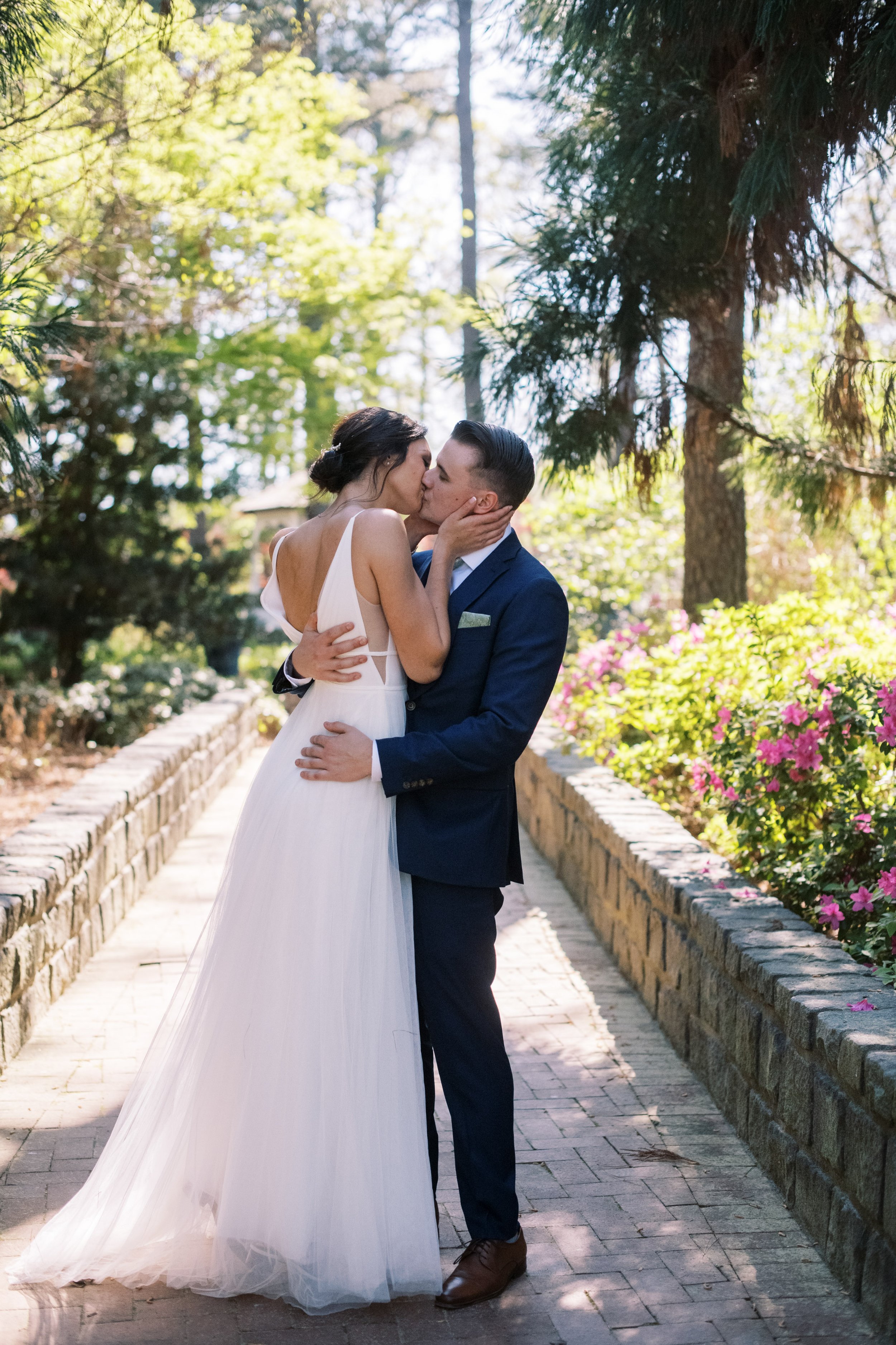 Bride and Groom Kiss in Pathway Cape Fear Botanical Garden Wedding