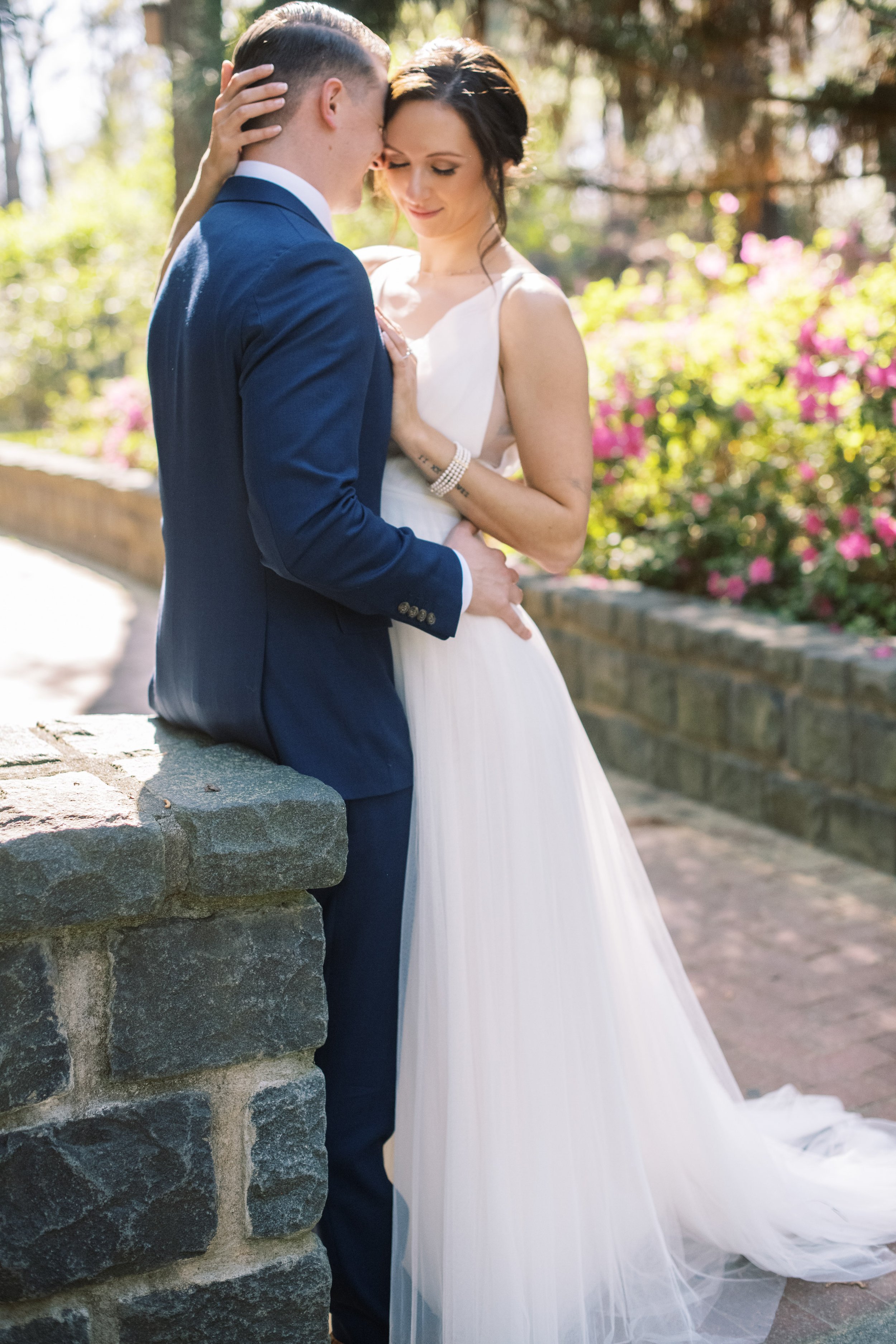 Bride and Groom Golden Hour Stone Wall Cape Fear Botanical Garden Wedding Fancy This Photography