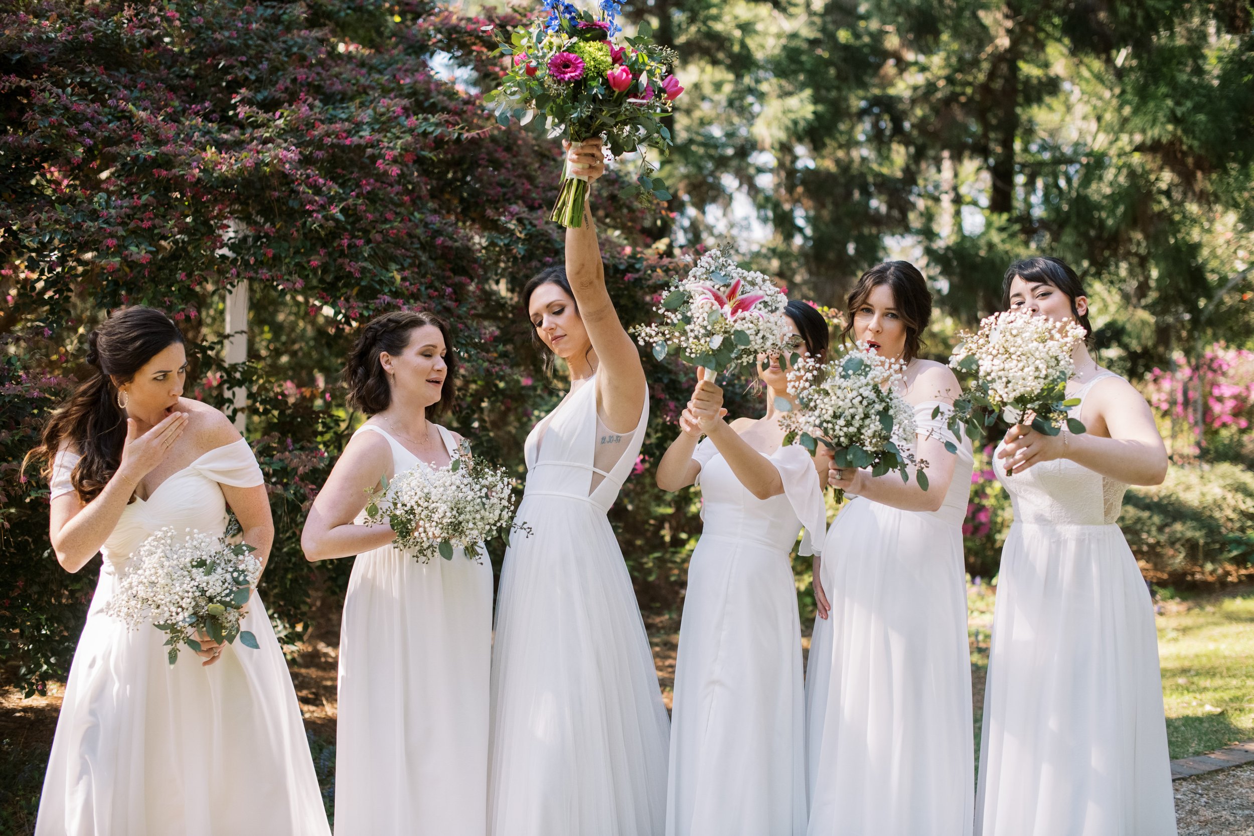 Bridesmaids in White Dresses Celebrating with Bride Cape Fear Botanical Garden Wedding Fancy This Photography