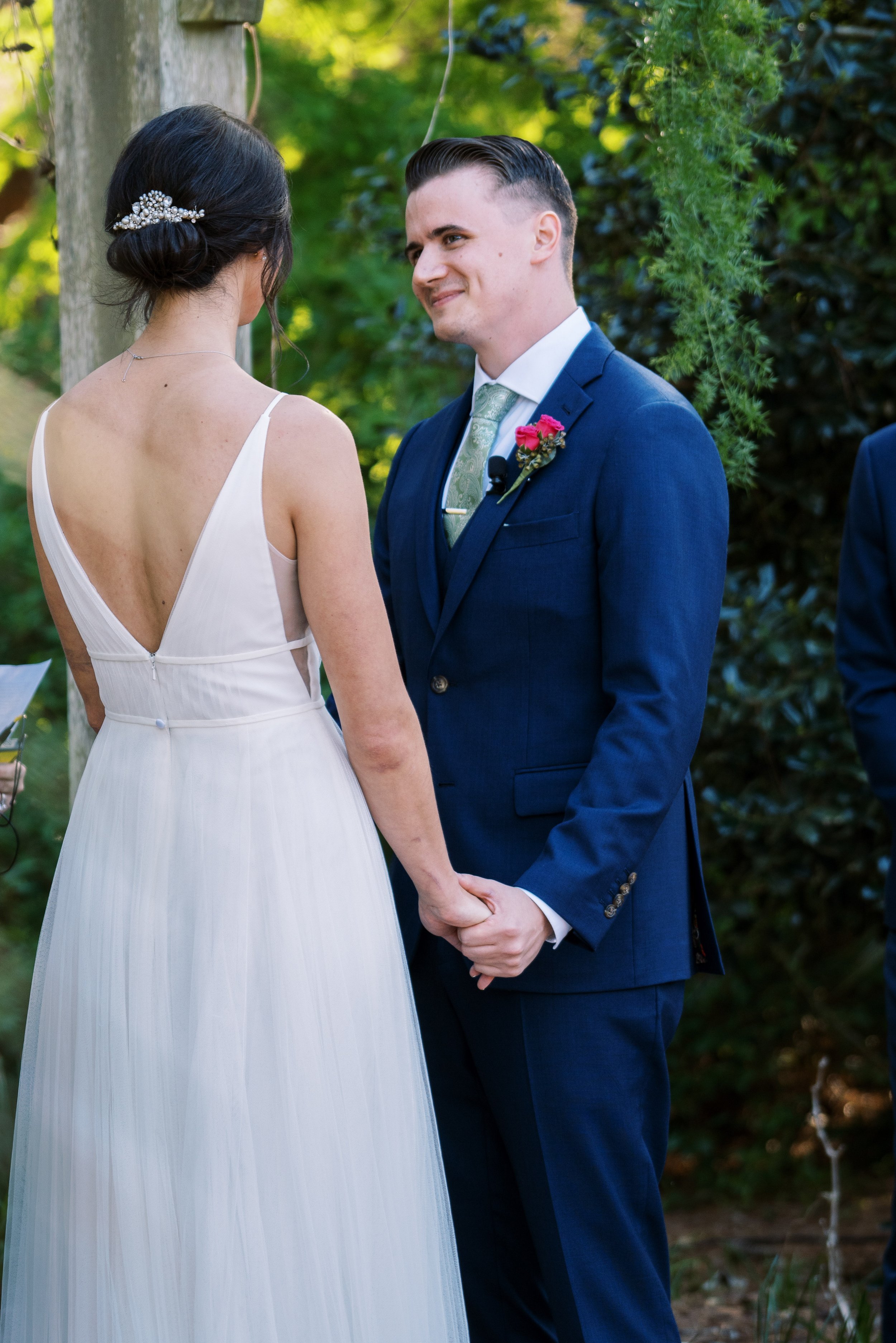 Groom Looks at Bride During Ceremony Vows in Cape Fear Botanical Garden wedding. 