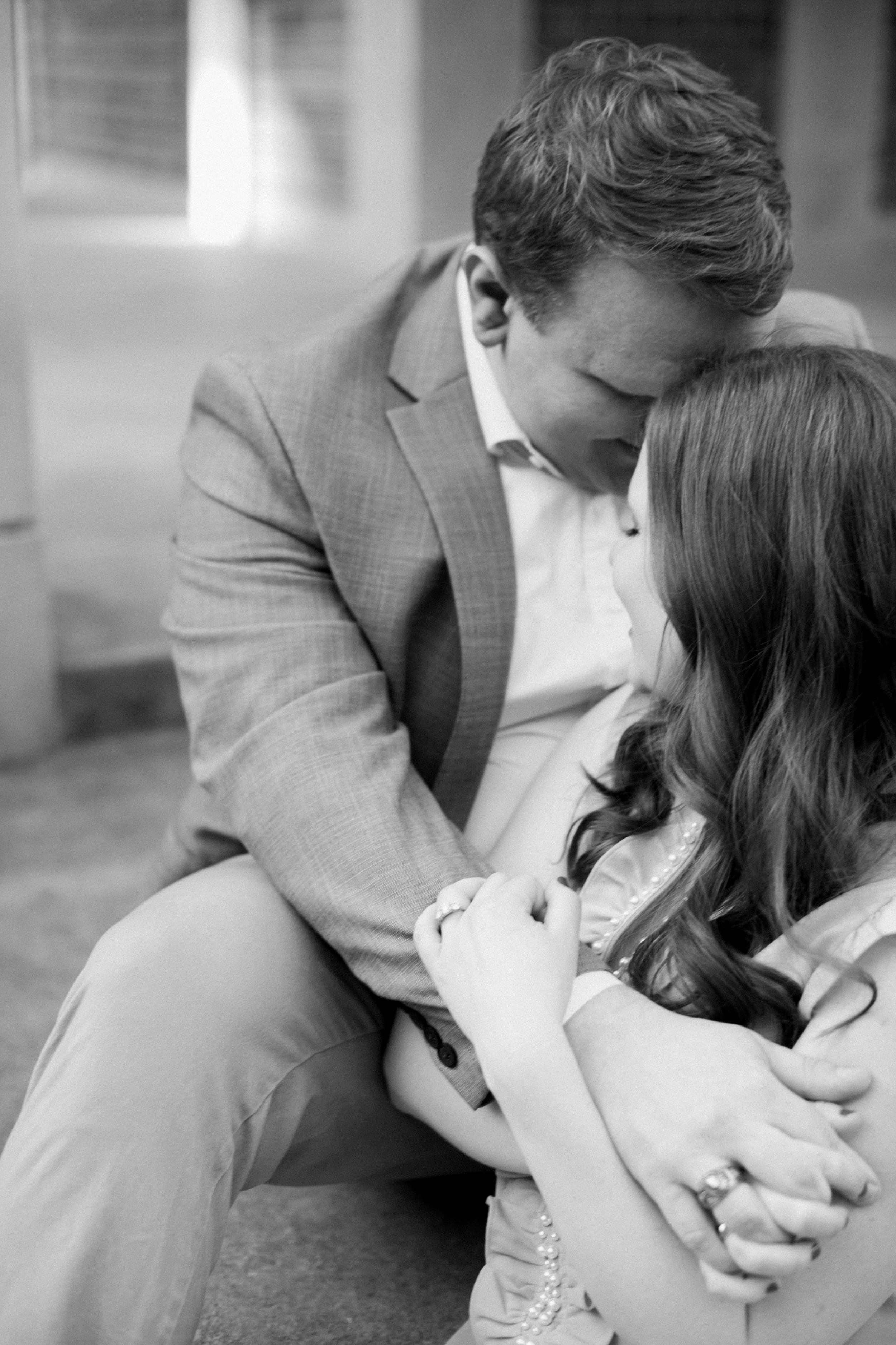 Black and White Bell Tower Couple Embraces on Staircase UNC Chapel Hill Engagement Photos Fancy This Photography