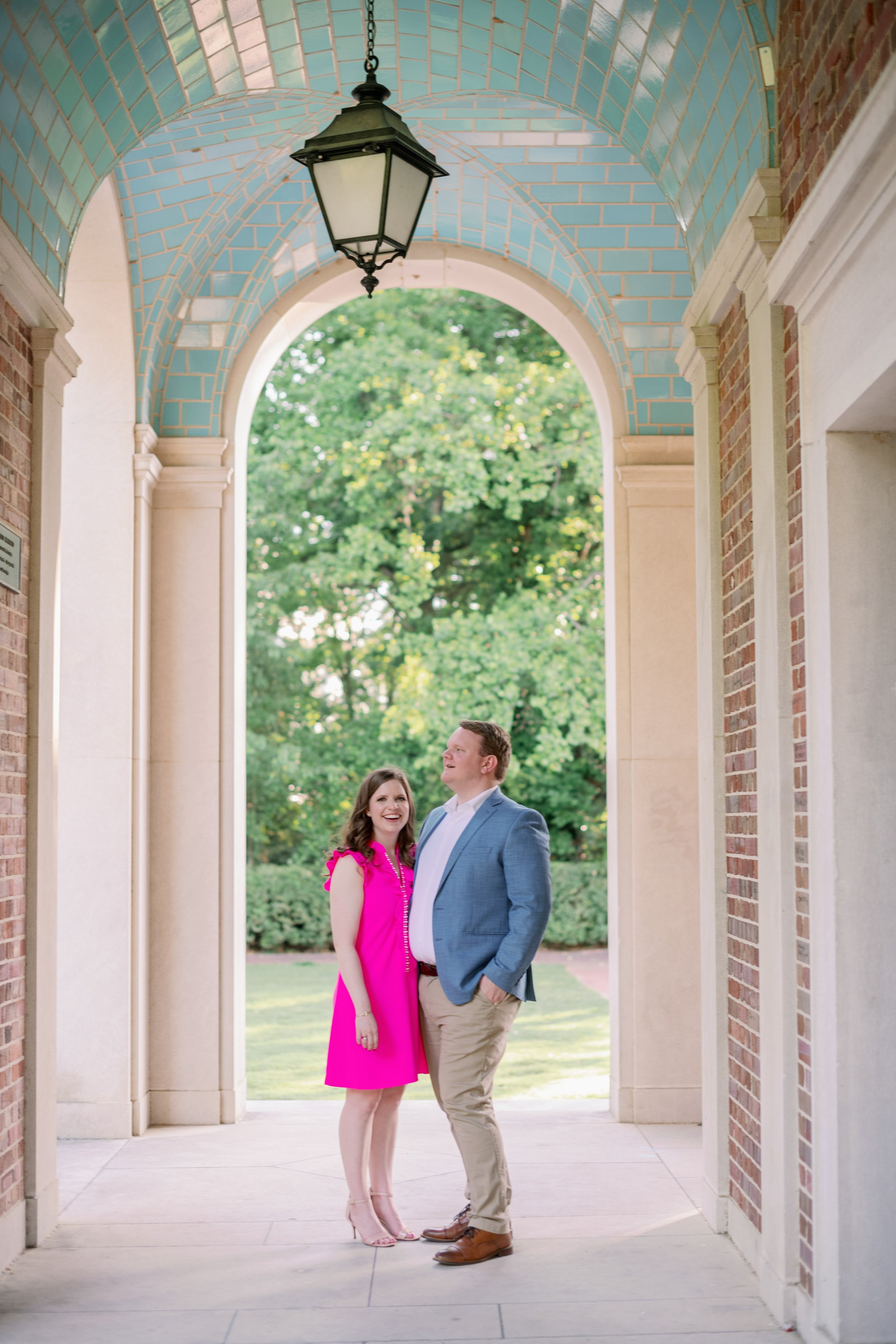 Couple Under Blue Bell Tower Archway UNC Chapel Hill Engagement Photos Fancy This Photography