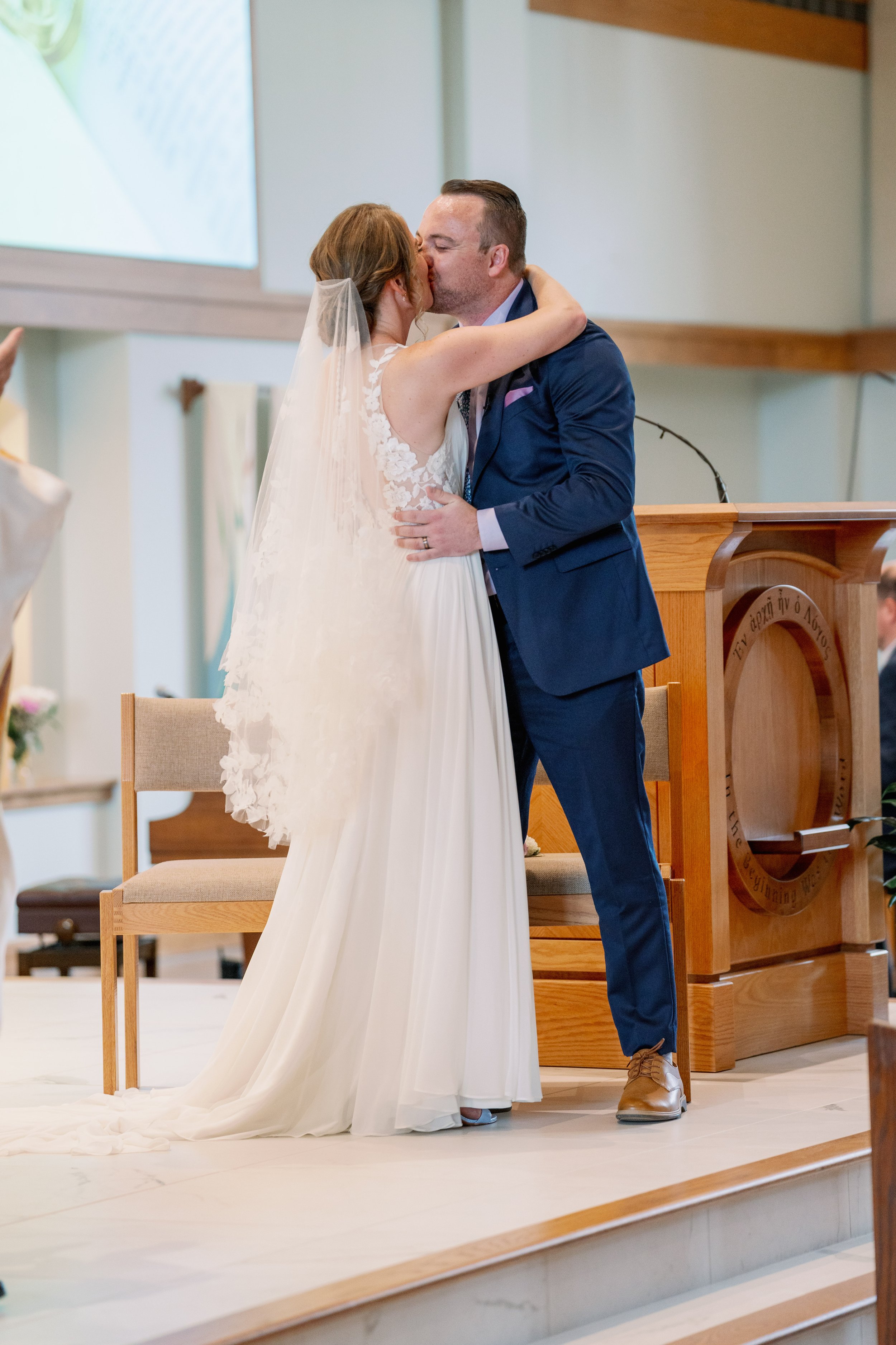 Wedding Ceremony Kiss Holy Infant Catholic Church Durham North Carolina Fancy This Photography