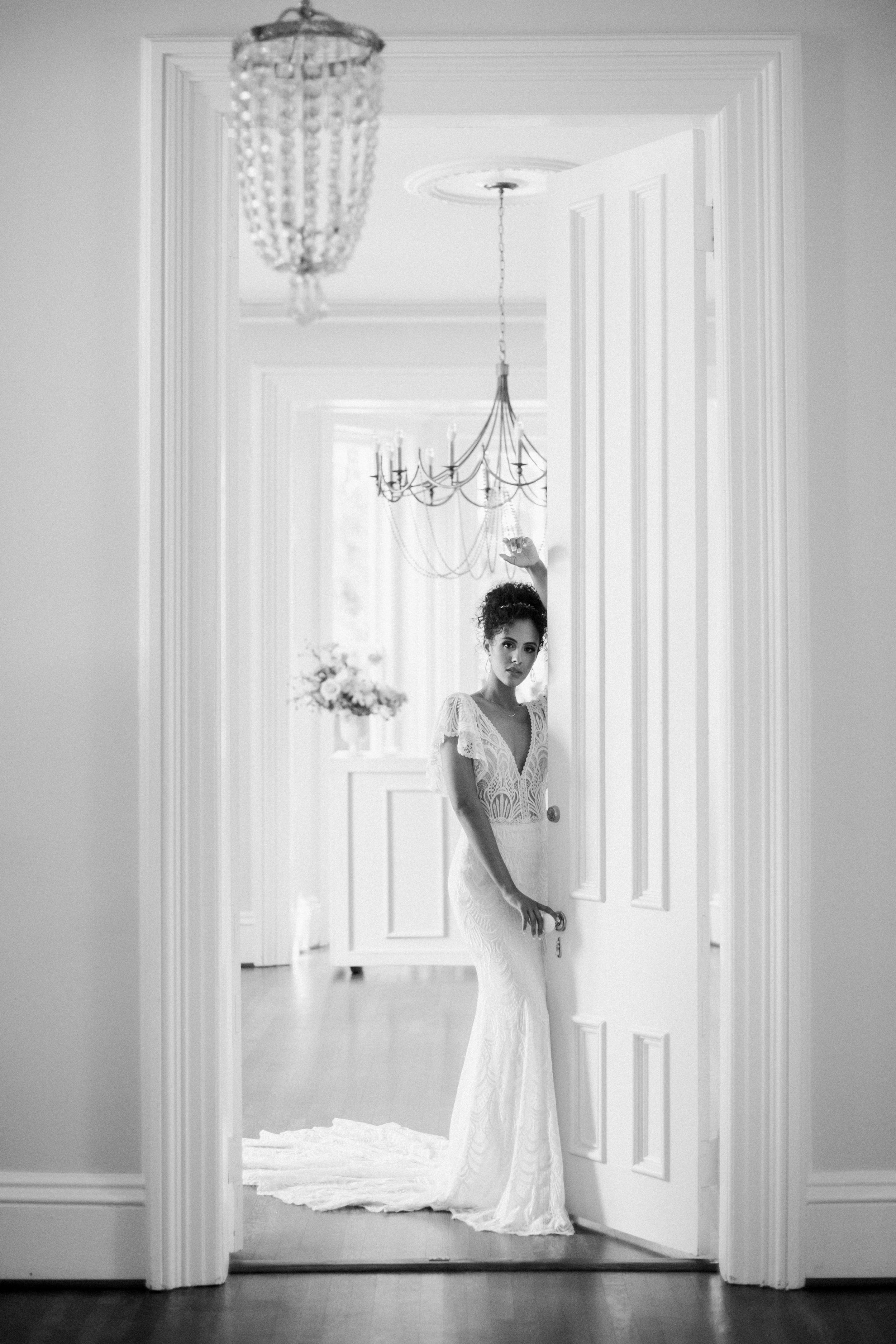 Black and White Image of Bride in Doorway The McAlister-Leftwich House Wedding Venue Fancy This Photography
