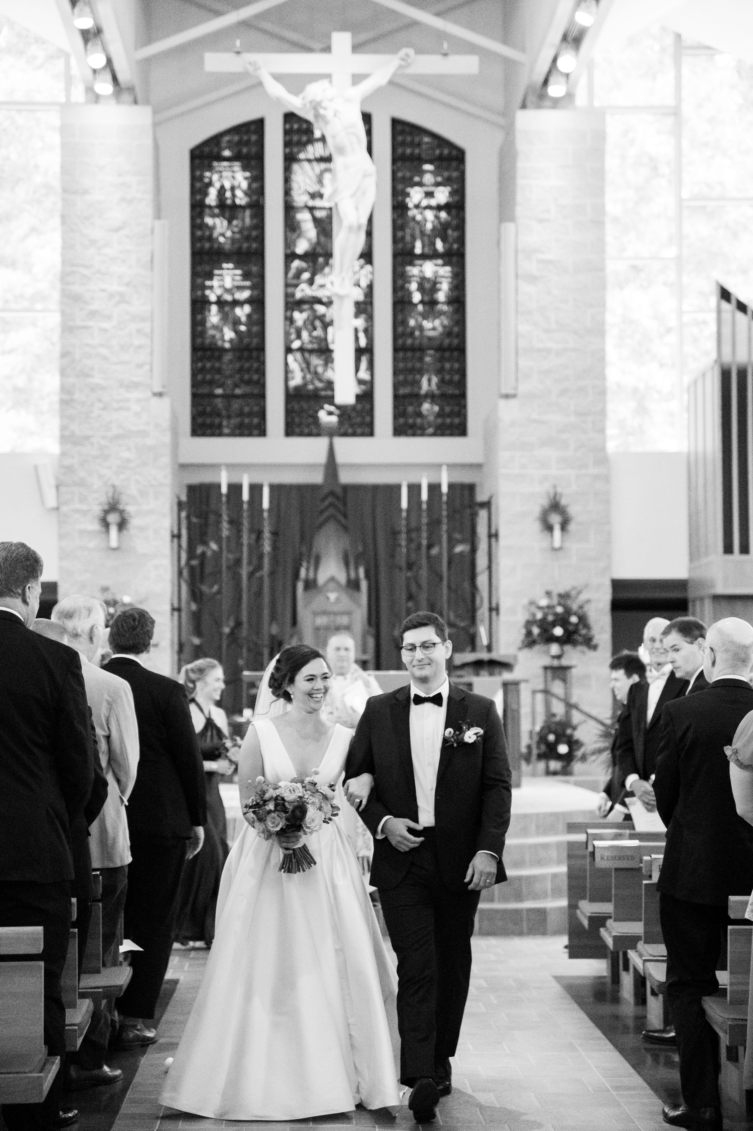 Bride and Groom Exit St. Thomas More Catholic Church UNC Chapel Hill Wedding at The Carolina Inn Fancy This Photography