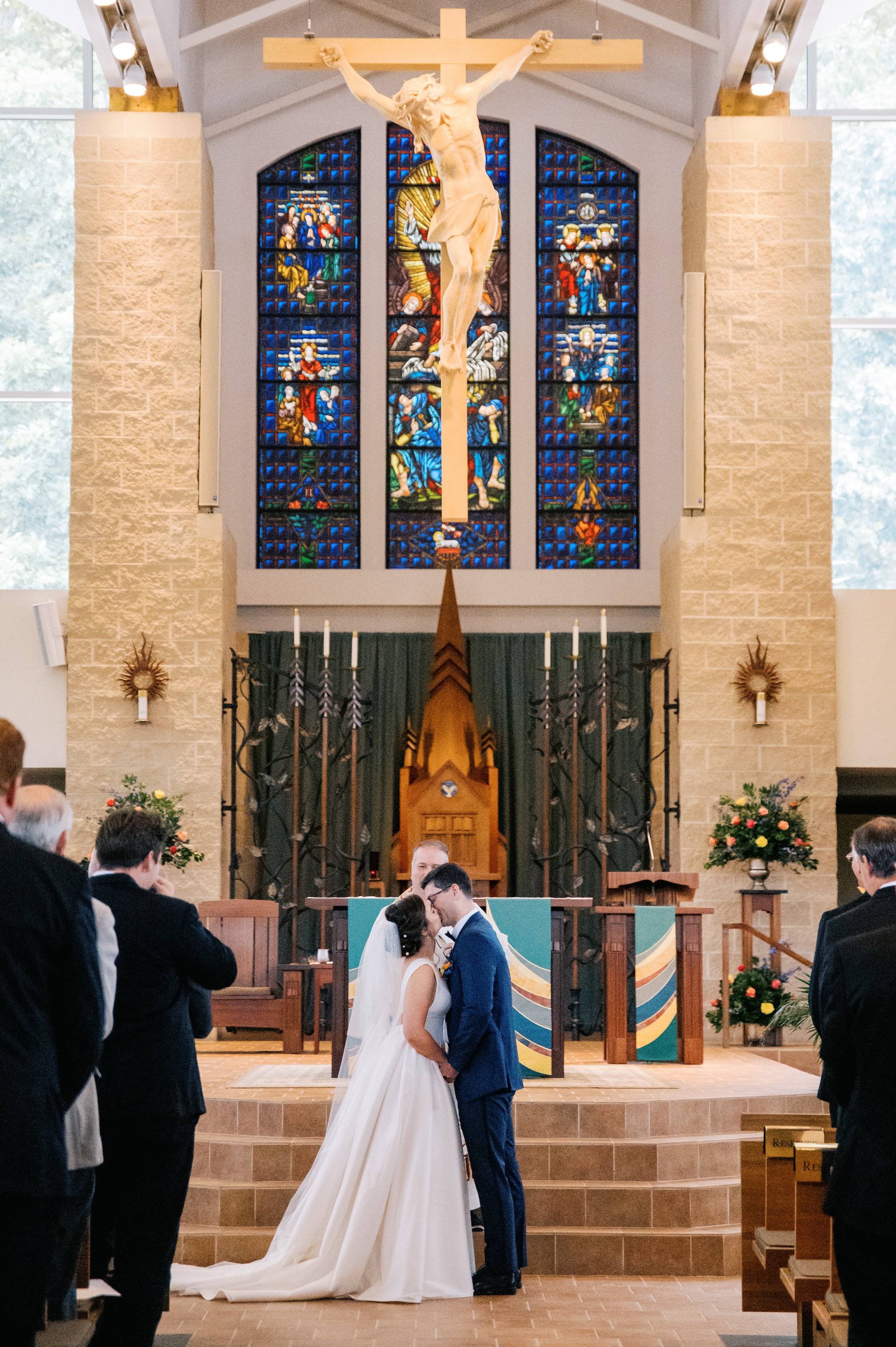 Bride and Groom Kiss St. Thomas More Catholic Church UNC Chapel Hill Wedding at The Carolina Inn Fancy This Photography