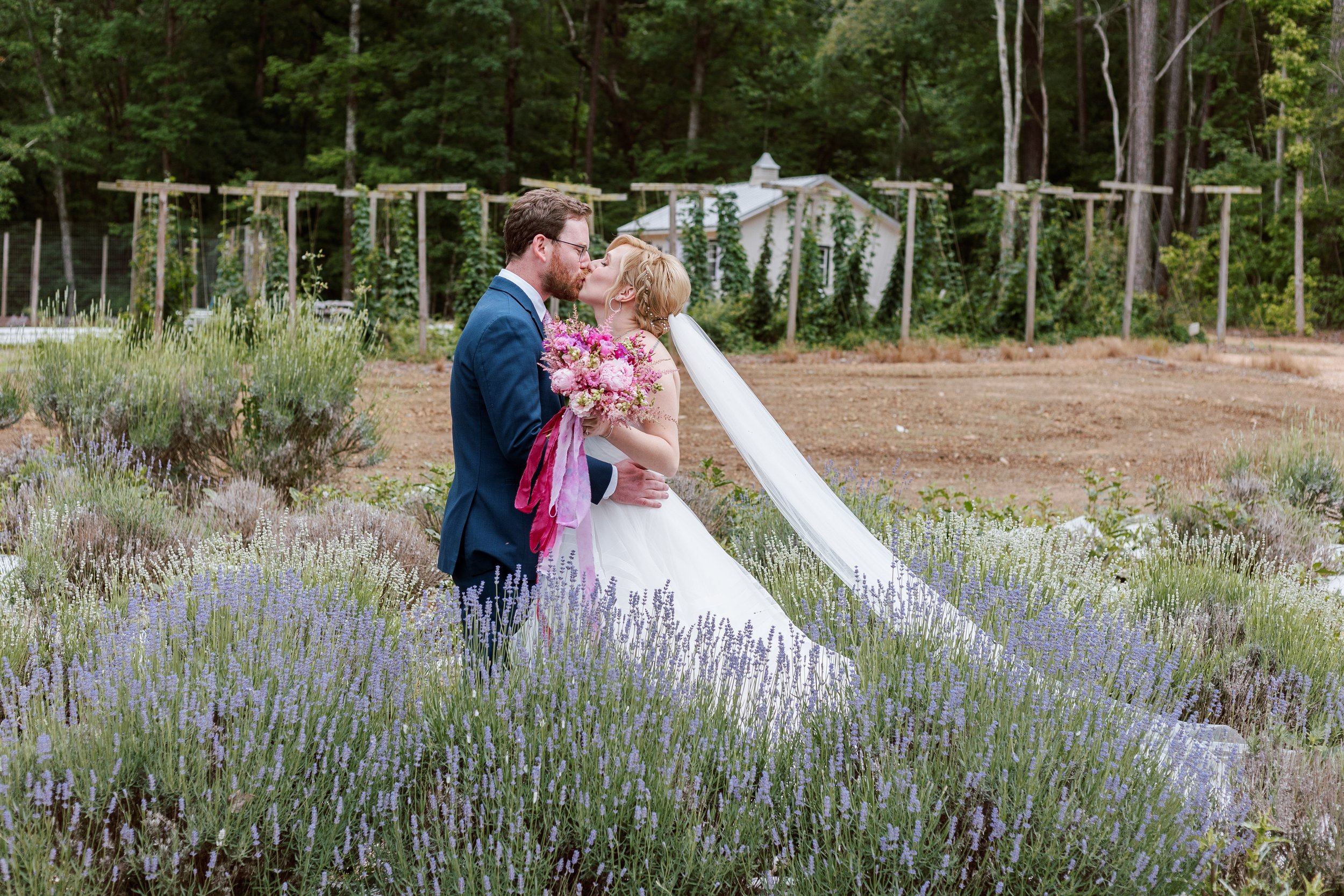 Lavender Field First Look Kiss Bride and Groom Wedding at Lavender Oaks Farm in Chapel Hill Fancy This Photography