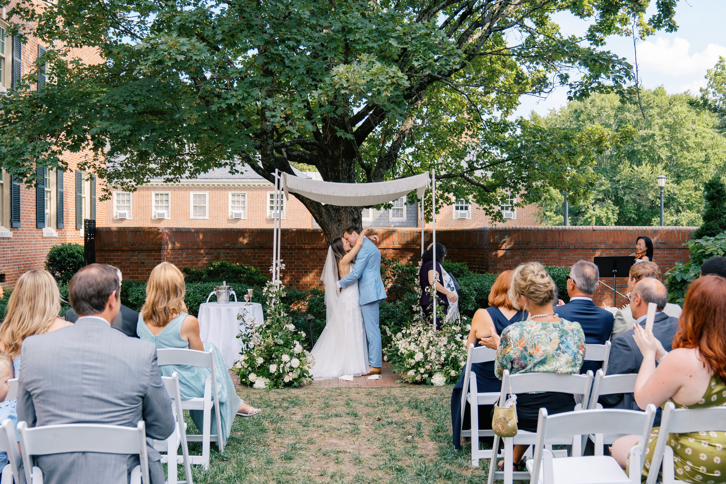 Kiss Bride and Groom Outdoor Ceremony Jewish Wedding at The Carolina Inn Chapel Hill North Carolina Fancy This Photography