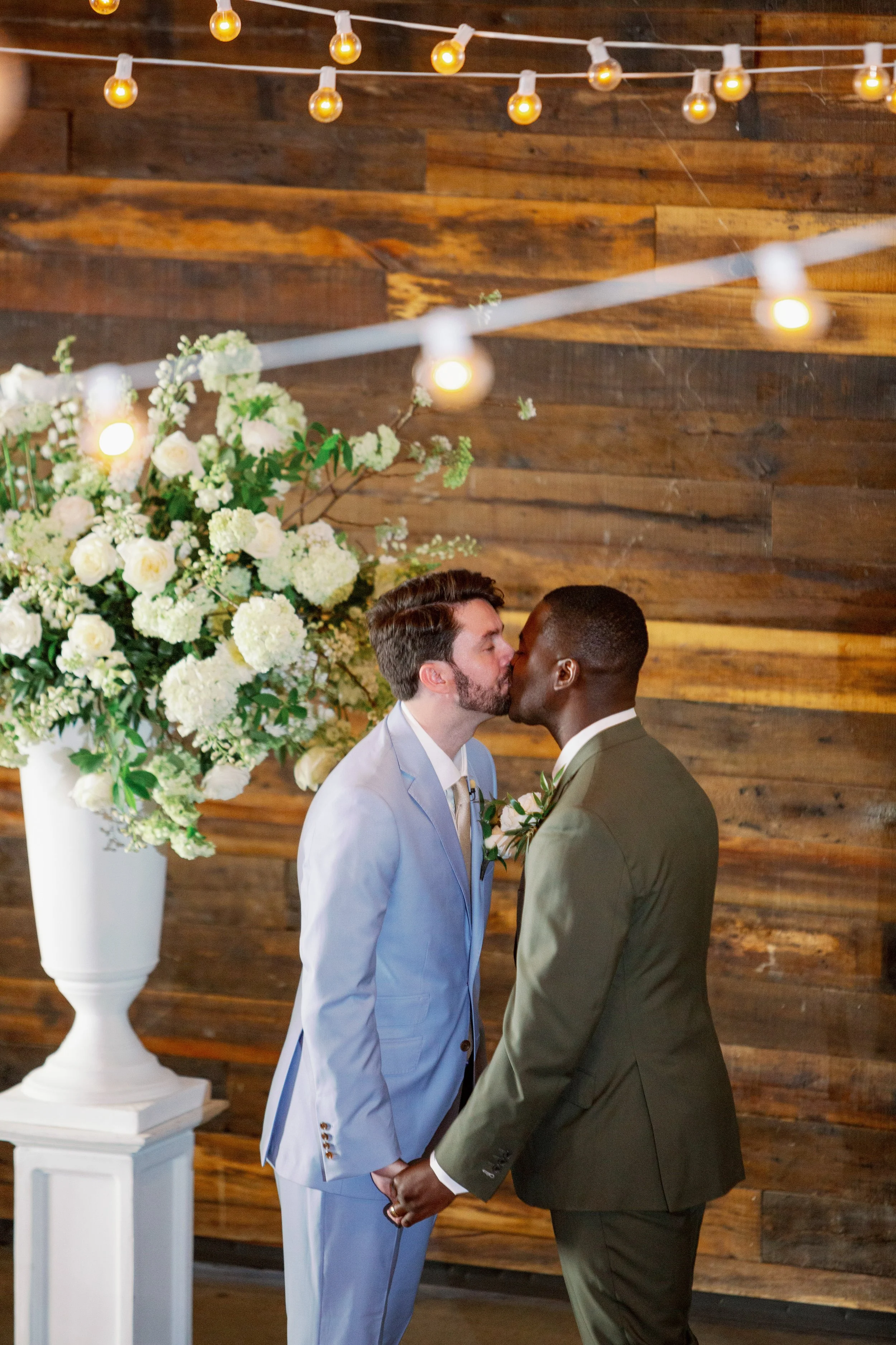 Same sex couple sharing their first kiss during Market Hall wedding ceremony