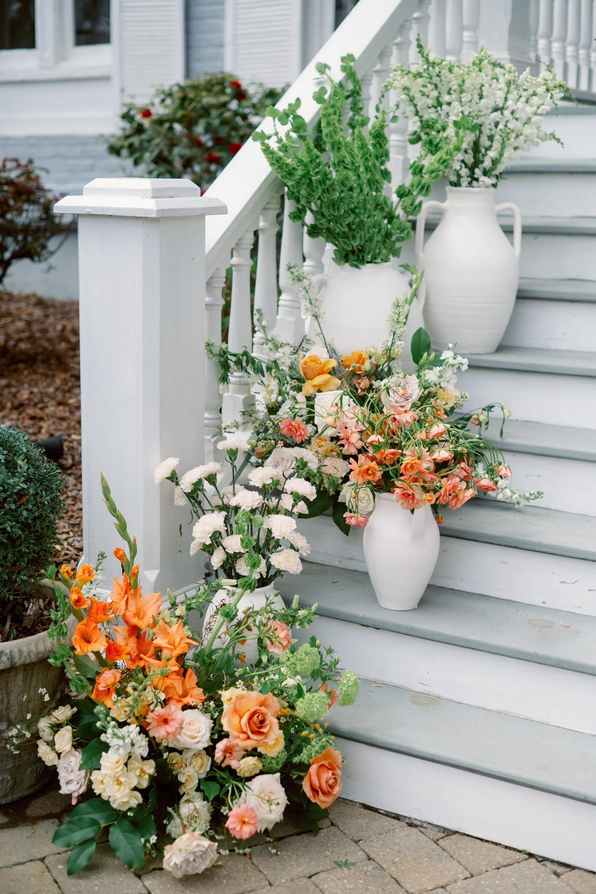 ceremony entrance florals on steps at McAlister-Leftwich House wedding in Greensboro North Carolina