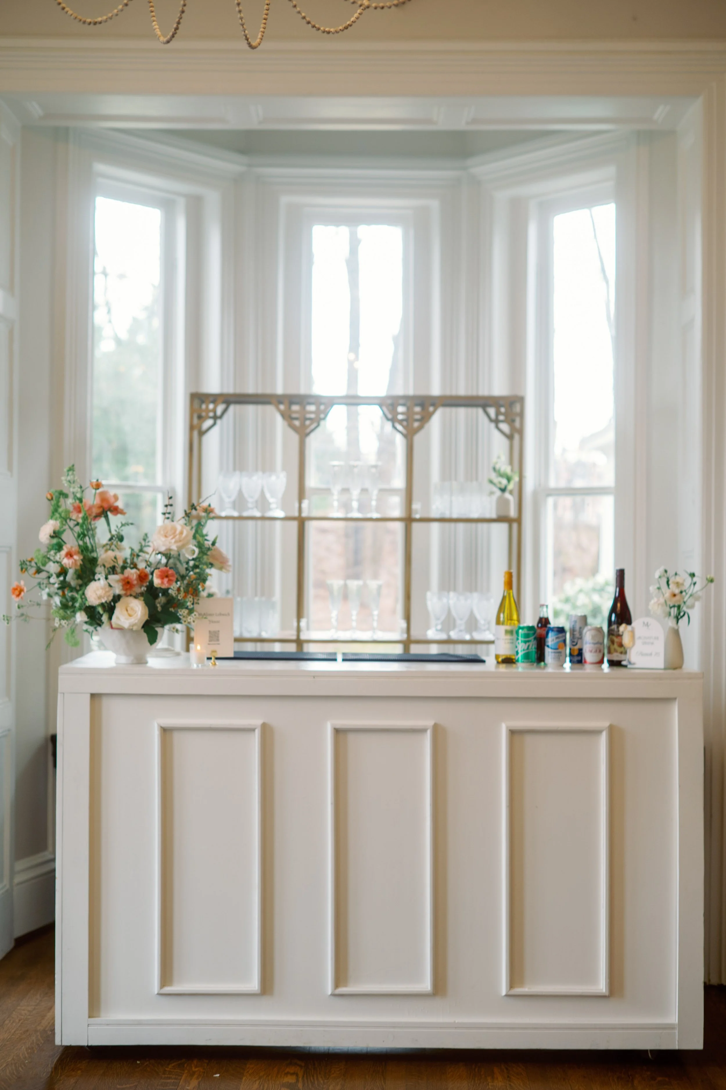 indoor bar setup at McAlister-Leftwich House wedding in Greensboro North Carolina with floral accents