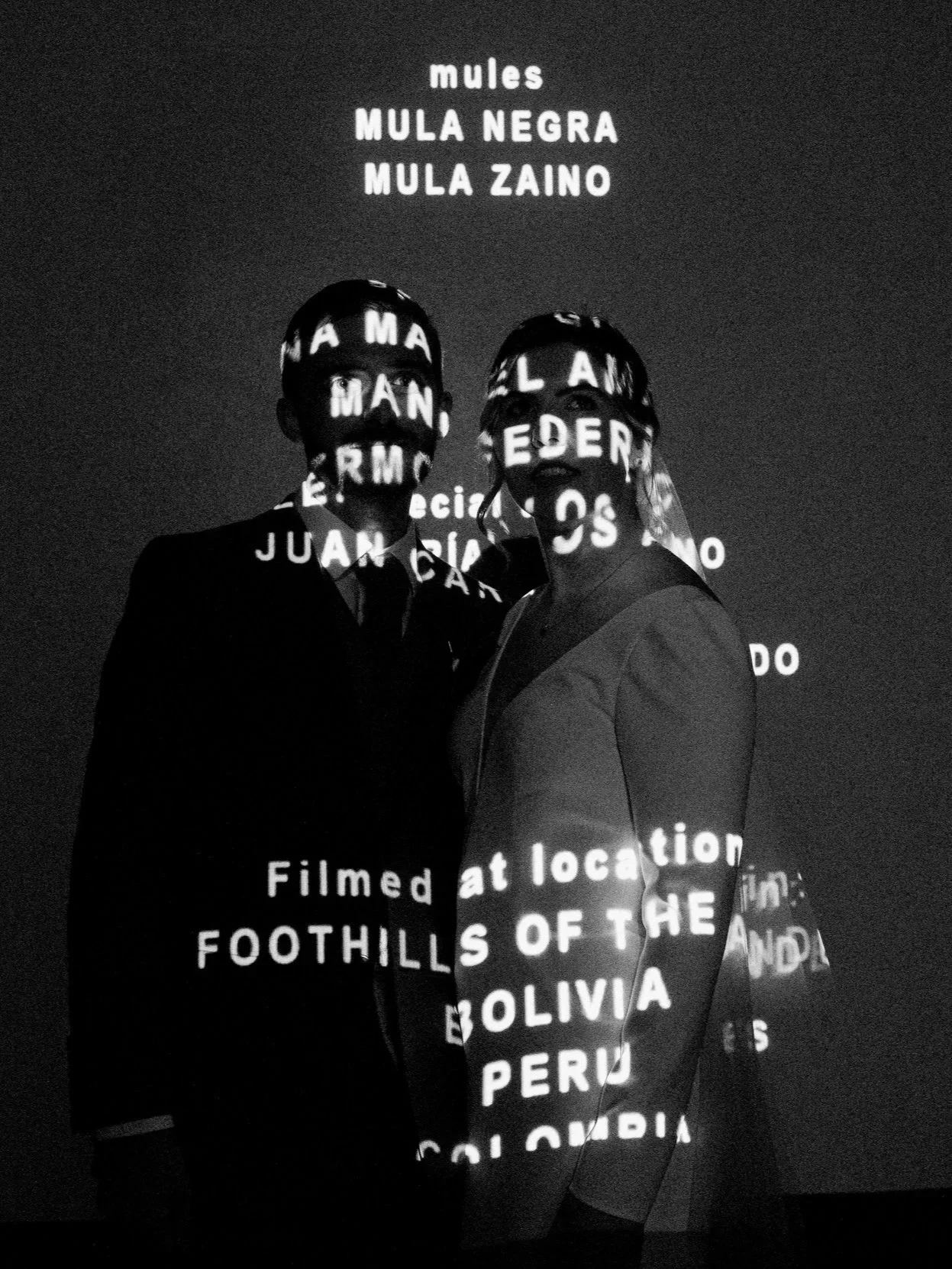 Couple standing together in front of projection art installation at 21C Museum Hotel wedding in Durham NC