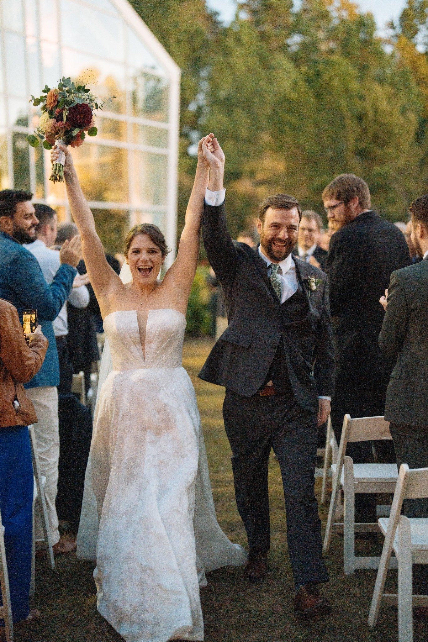 Look at her face walking back down that aisle. That is the whole reason we do this. Jen and Michael at the Museum of Life and Science in Durham, married among the gardens as golden hour did exactly what golden hour does when you let it. One of our fa