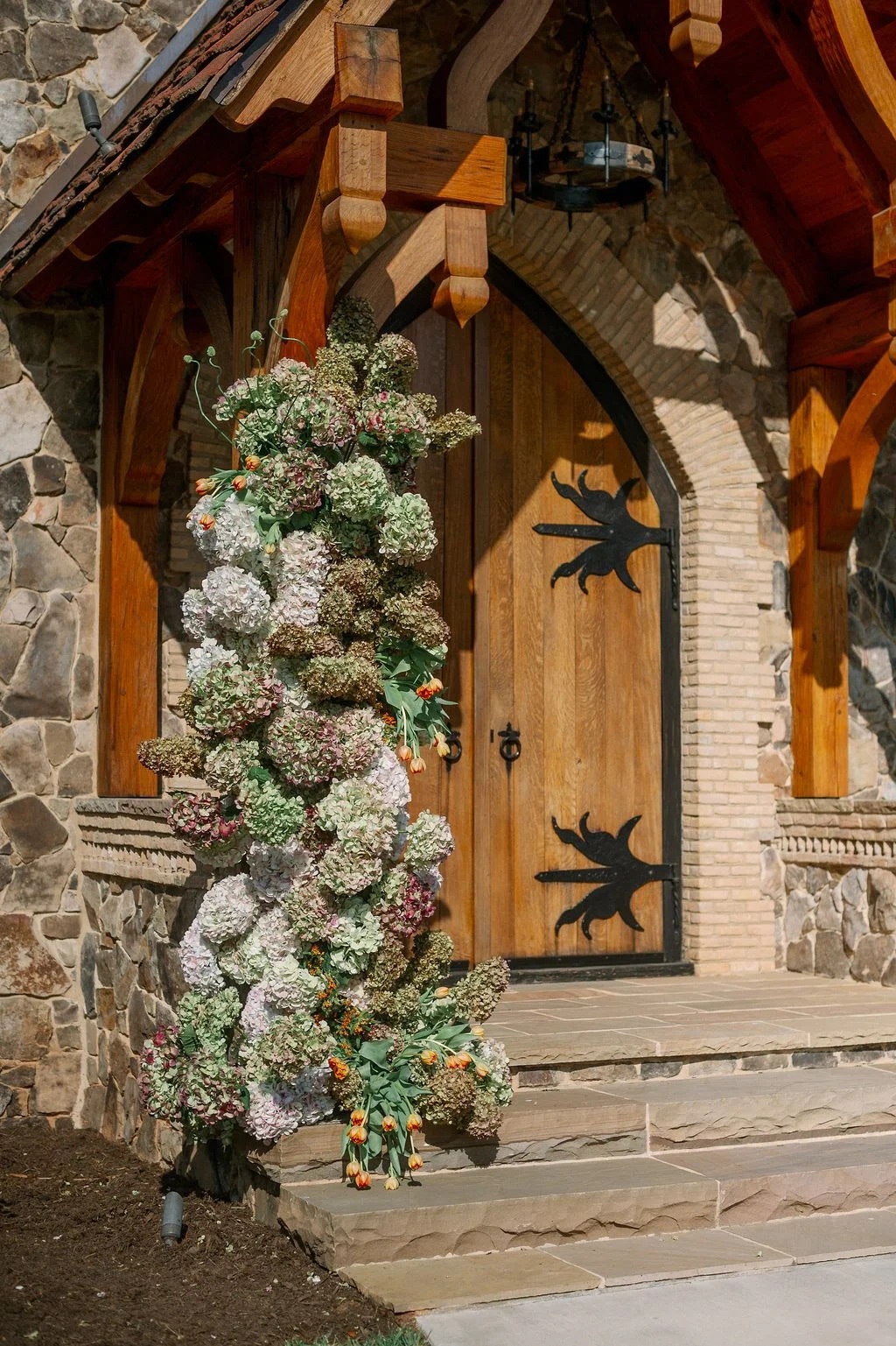  Cascading floral installation framing the chapel doorway at The Little Chapel at Haven Ridge 