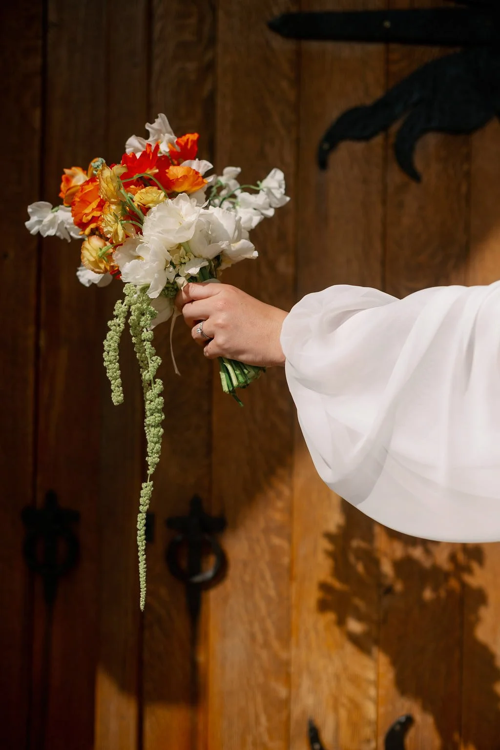  Bride holding a spring bouquet with trailing amaranthus at The Little Chapel at Haven Ridge 