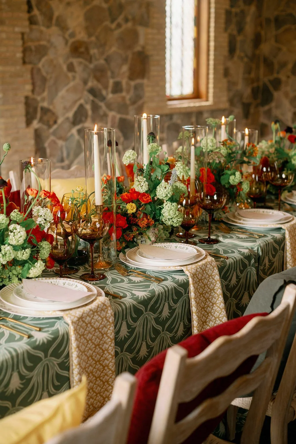  Candlelit reception tablescape with green linens and florals inside the chapel at The Little Chapel at Haven Ridge 