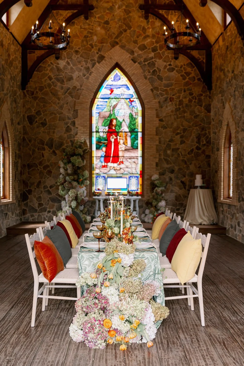 Reception table set inside the chapel beneath the stained glass window at The Little Chapel at Haven Ridge, Winston-Salem 