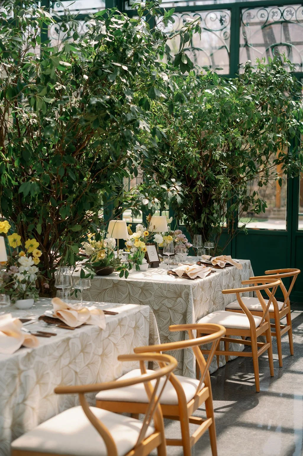  Wishbone chairs and a tree-lined reception table in the Solarium at The Little Chapel at Haven Ridge 