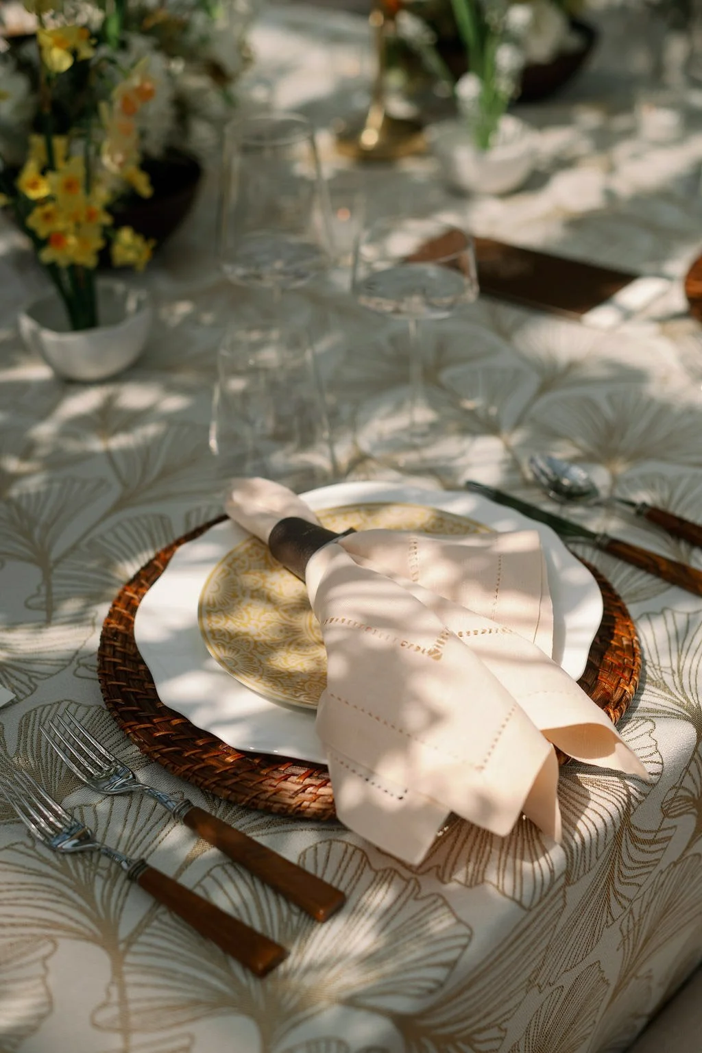  Gold charger and napkin on ginkgo-patterned linen in the Solarium at The Little Chapel at Haven Ridge 
