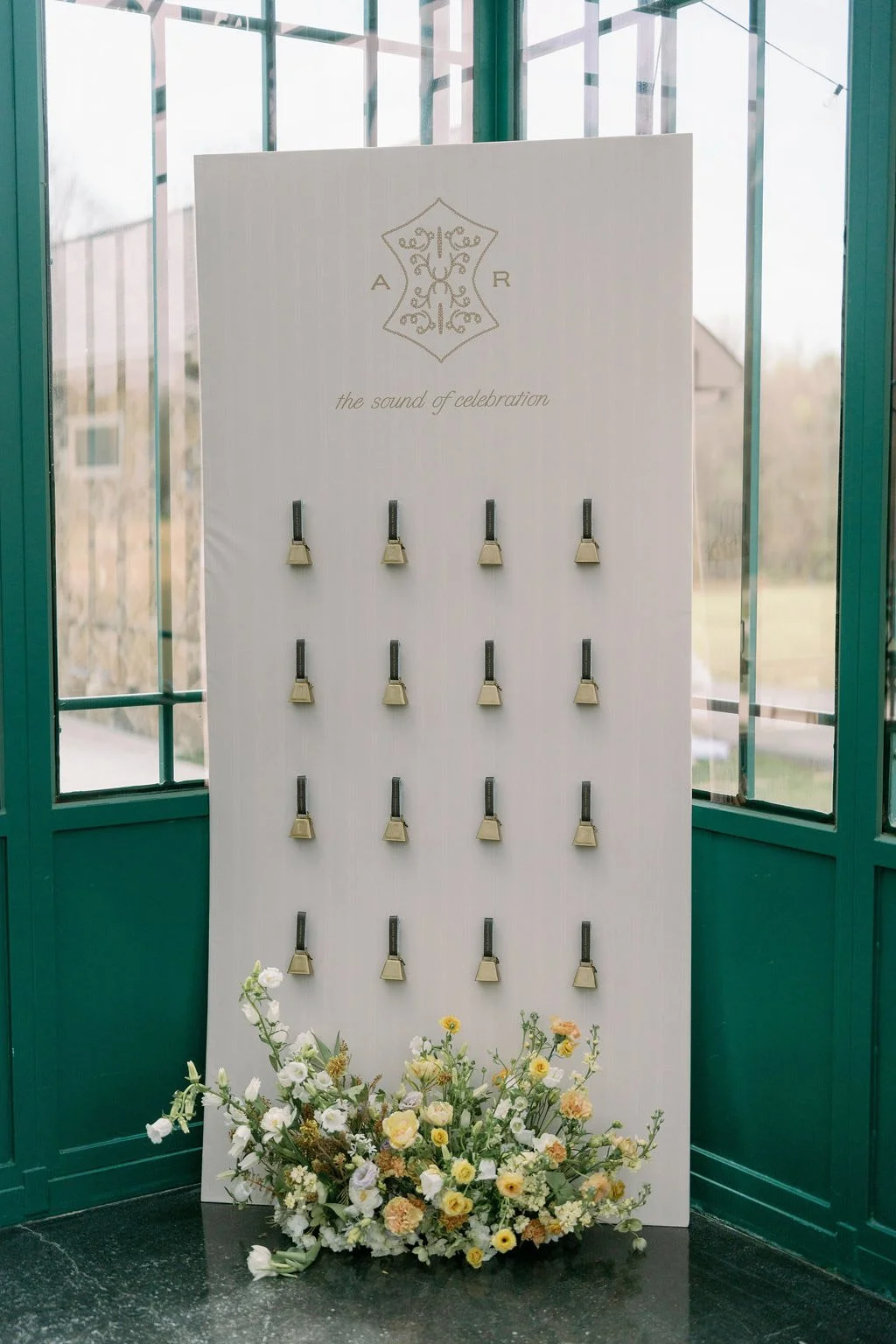  Monogrammed escort card display with spring florals in the Solarium at The Little Chapel at Haven Ridge, Winston-Salem 