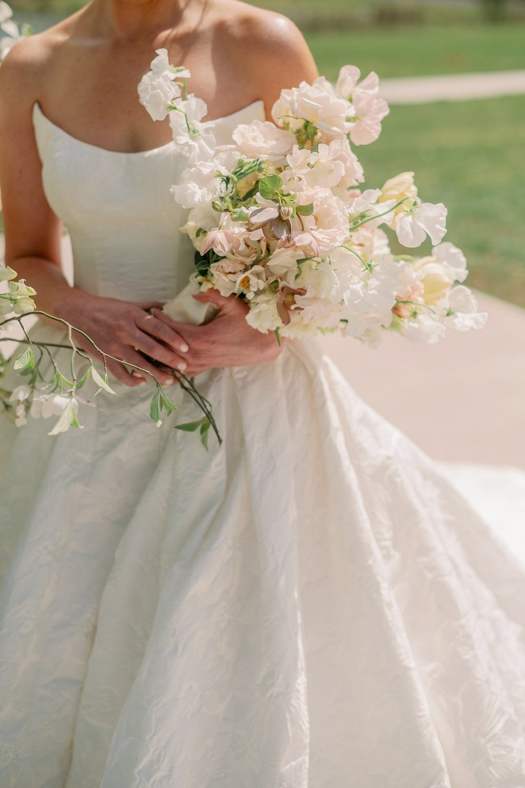  Bride holding a blush sweet pea bouquet at The Little Chapel at Haven Ridge 