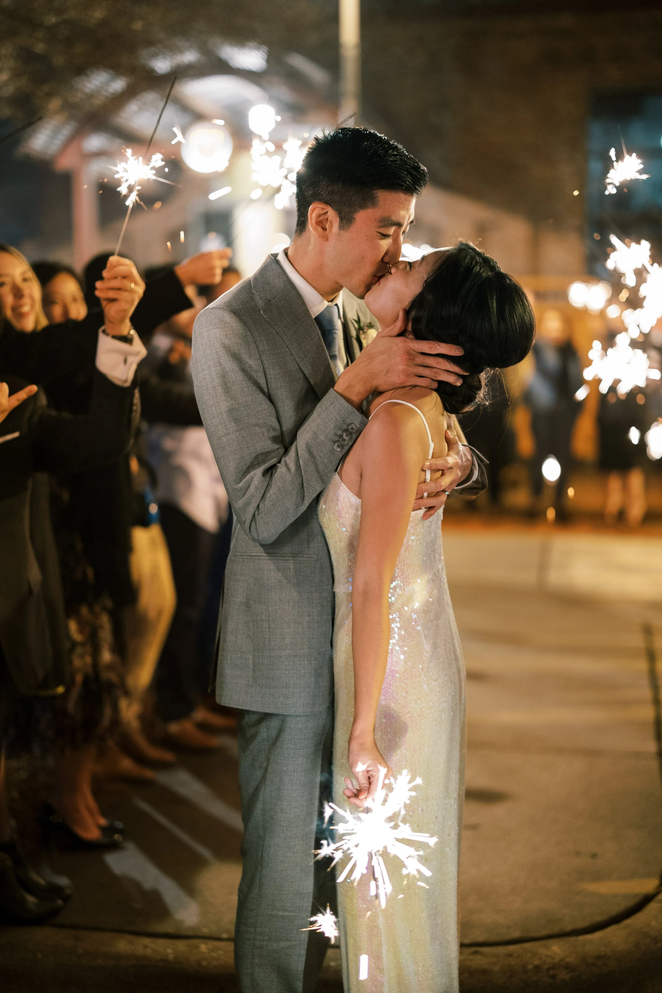 Bride and groom sharing a kiss during a sparkler exit at their Bay 7 wedding reception in Durham, North Carolina.