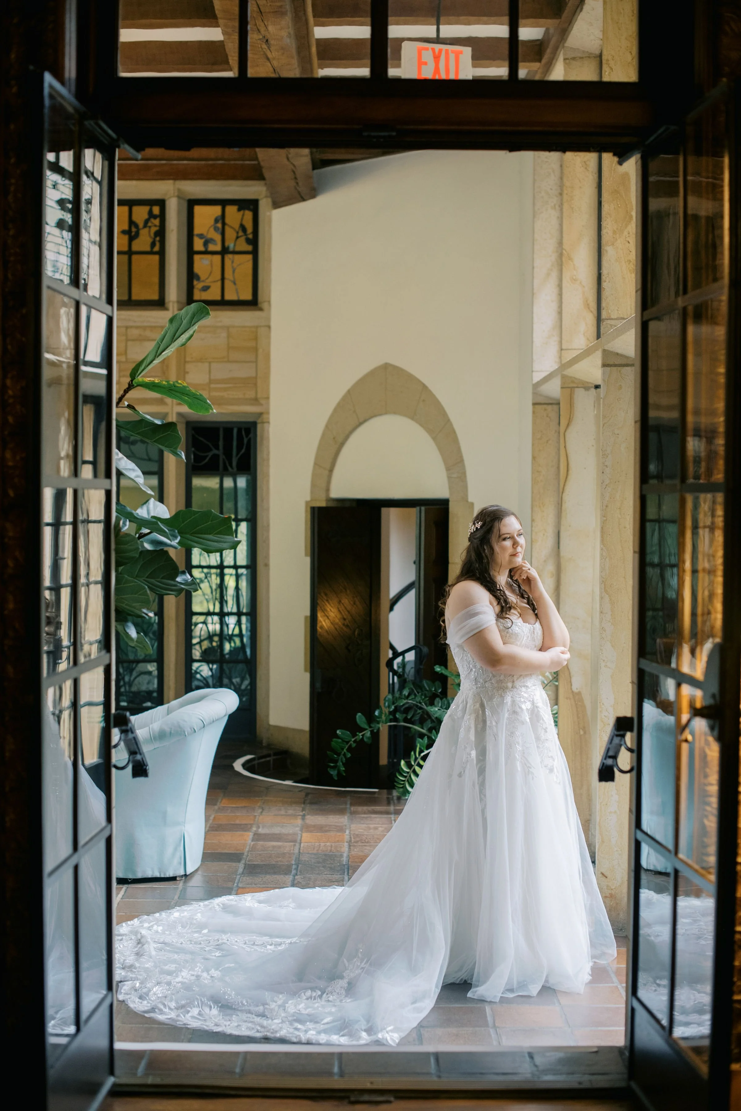 Bride in a flowing ball gown standing in an arched doorway at a Winston Salem NC wedding venue