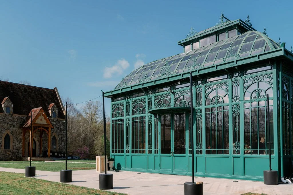 The emerald glass Solarium conservatory and stone chapel at The Little Chapel at Haven Ridge, a Winston-Salem NC wedding venue