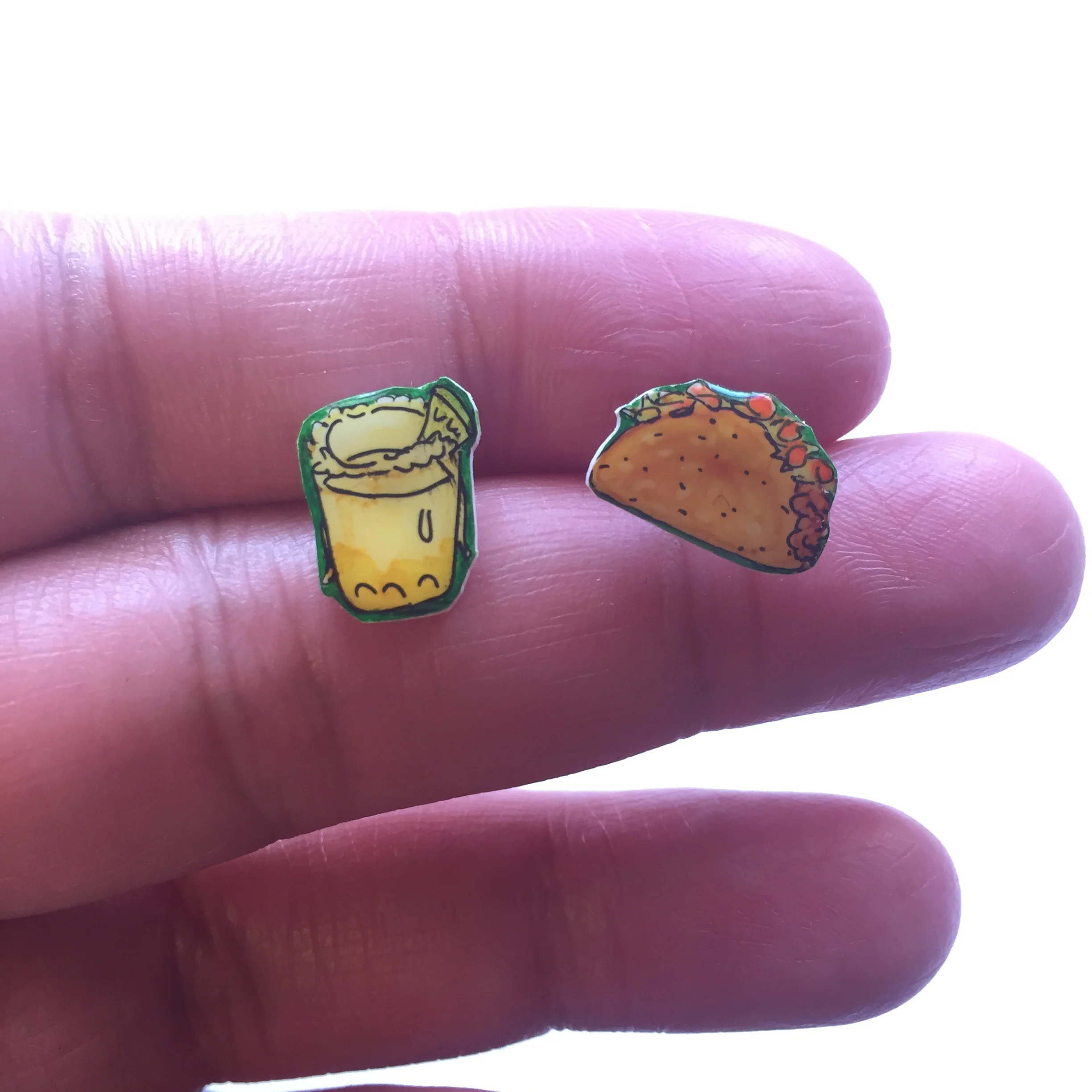 Excerpt of my listing for these taco Tuesday earrings: "Illustrate your ears! These shrink plastic button stud earrings make a unique gift for your sister, best friend, niece, mother, yourself, etc.! Taco Tuesday!! Everyone’s favorite day of the week! celebrate it in style, while you chomp on tacos & sip margaritas! Each design is hand drawn on shrink plastic, sealed with a clear coating and affixed to nickel-free earring posts"