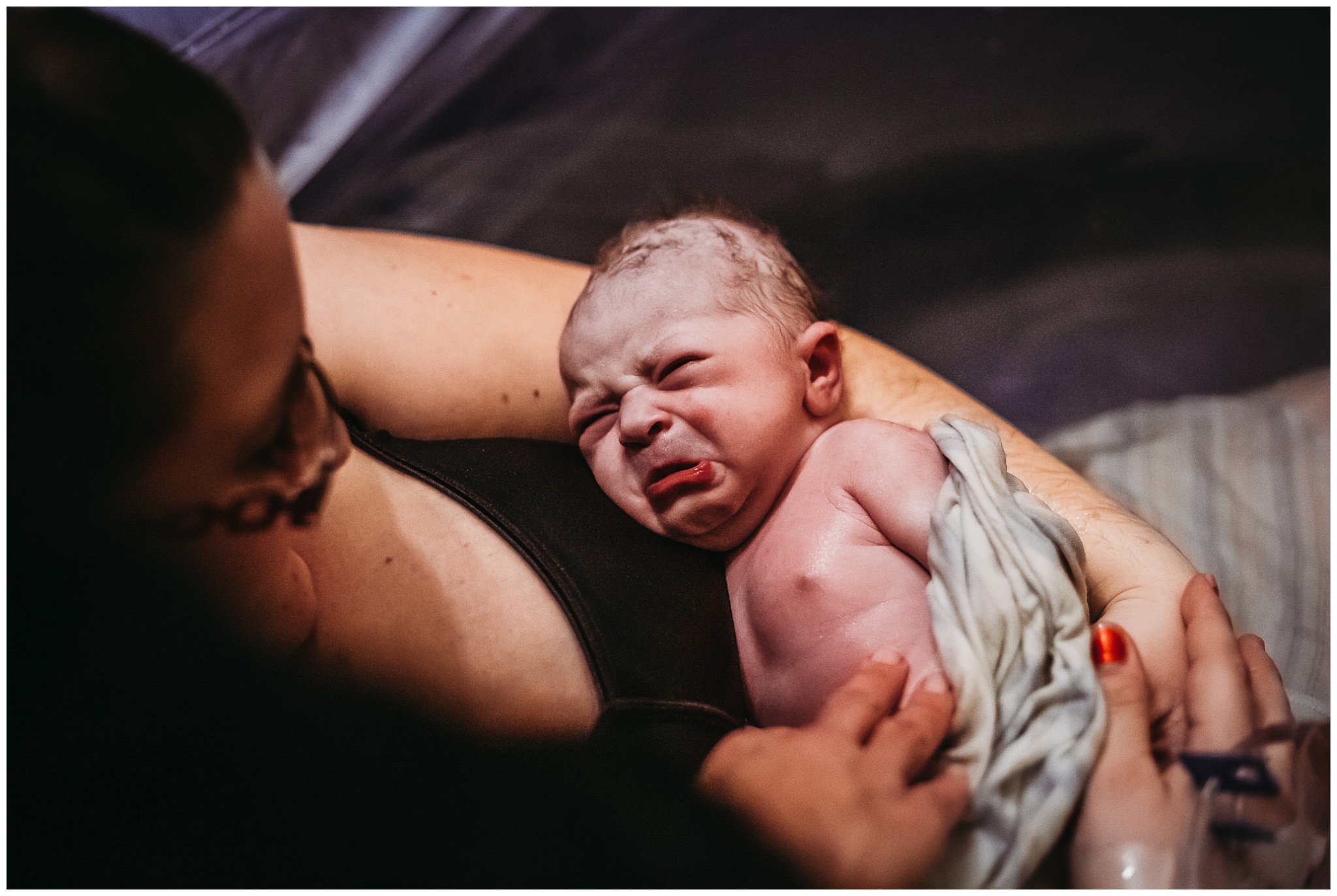 newborn photographed by birth photographer in birthing pool