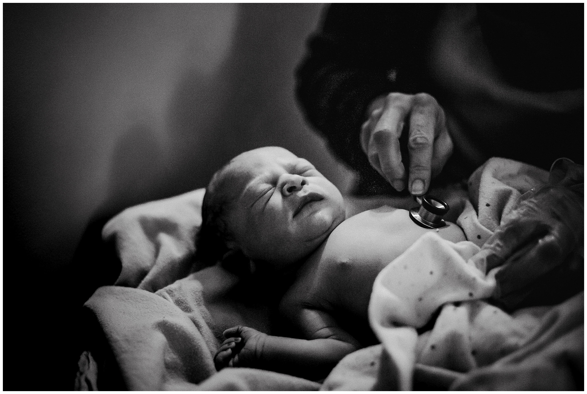 midwife examines newborn after birth