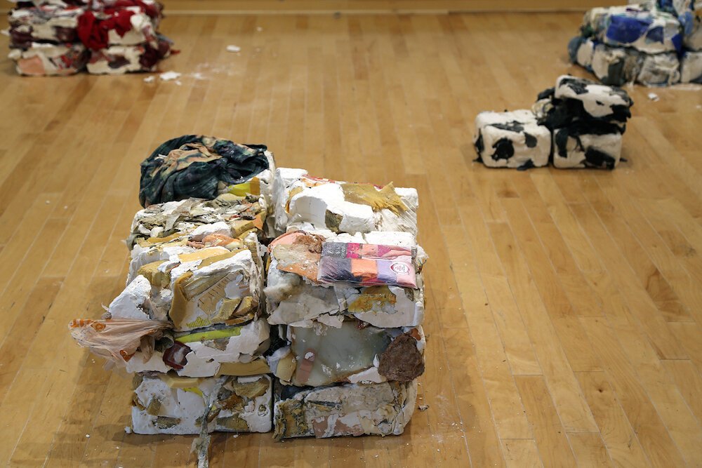   2015-2017  Personal belongings embedded in plaster each sculpture is approximately 2 x 2 feet  Belongings accumulated over two years are sorted by color (white, blue, orange, brown, black, red) and frozen in plaster time capsules. As part of the in