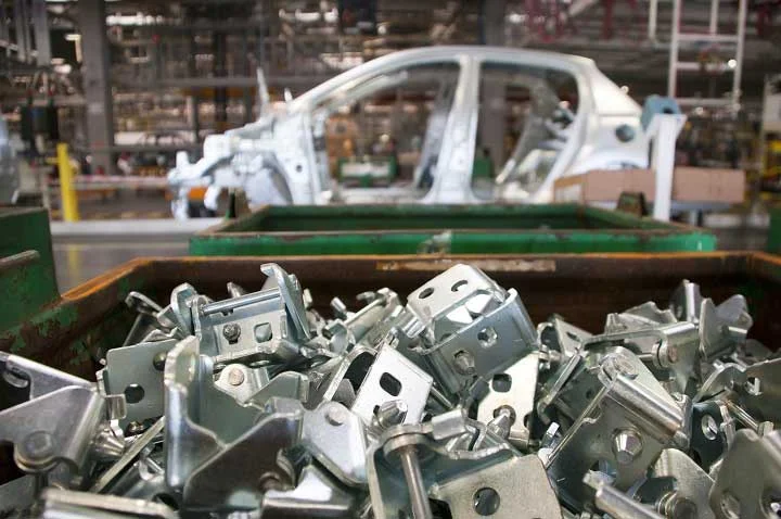 A bin of automotive parts being tracked in a factory.