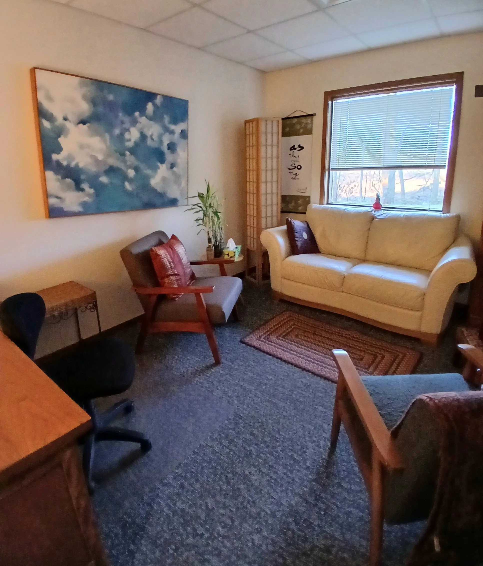 Jean's office with couch and eastern inspired art