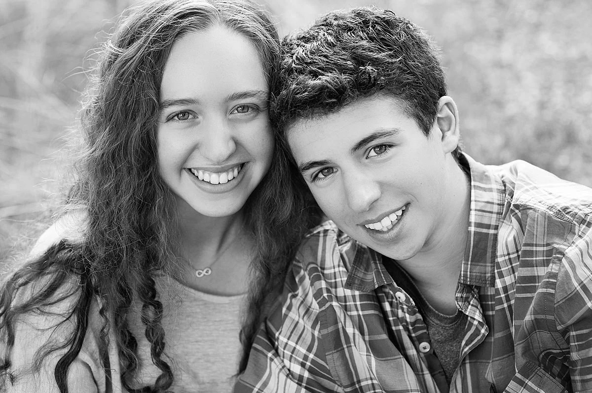 black and white photos of older siblings, infinity necklace and natural smiles. 