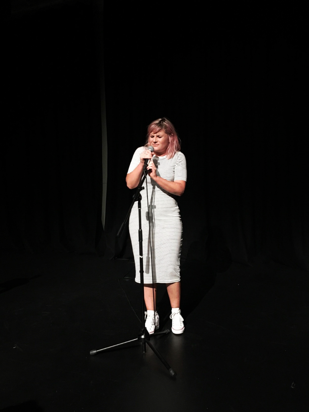Alice struggles with the height of the mike.