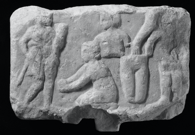 Figure 3.3 Marble votive relief from the Asklepieion at Athens showing a woman kneeling in front of a cult statue with votive body parts suspended behind her. Fourth century bce. Athens, Acropolis Museum 7232. Ht. 16 cm.