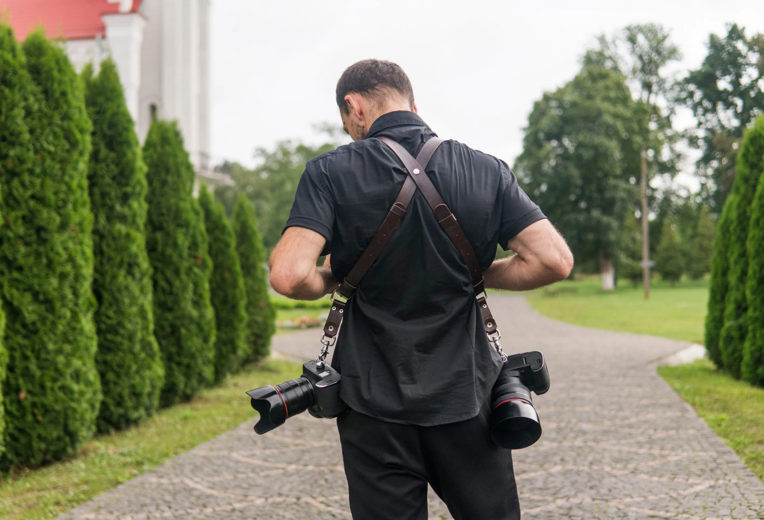 Photographer facing away with two cameras