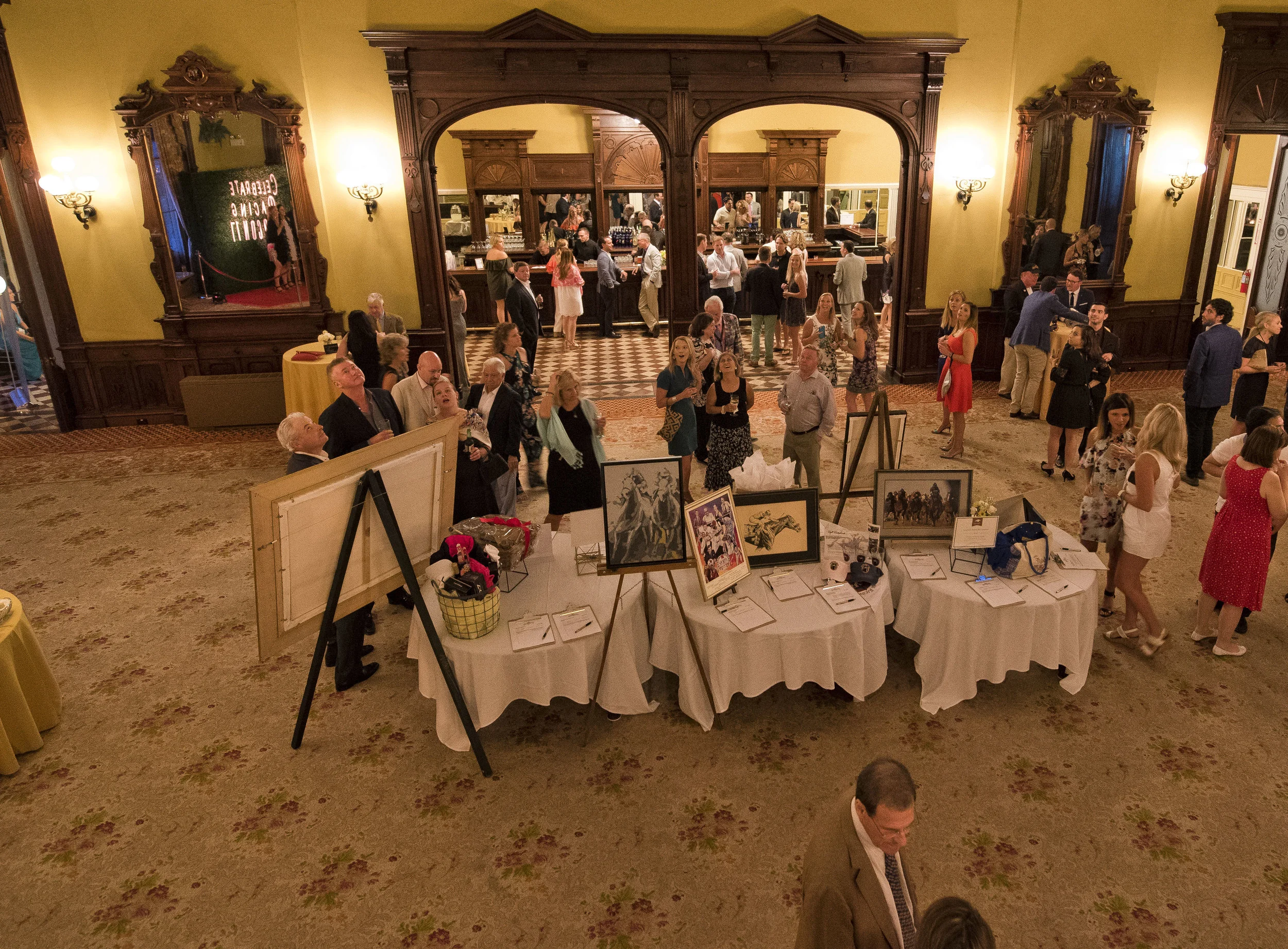 Guests peruse the silent auction benefitting the TAA and Man O'War Project at the Equestricon 2017 VIP Party (Eclipse Sportswire)
