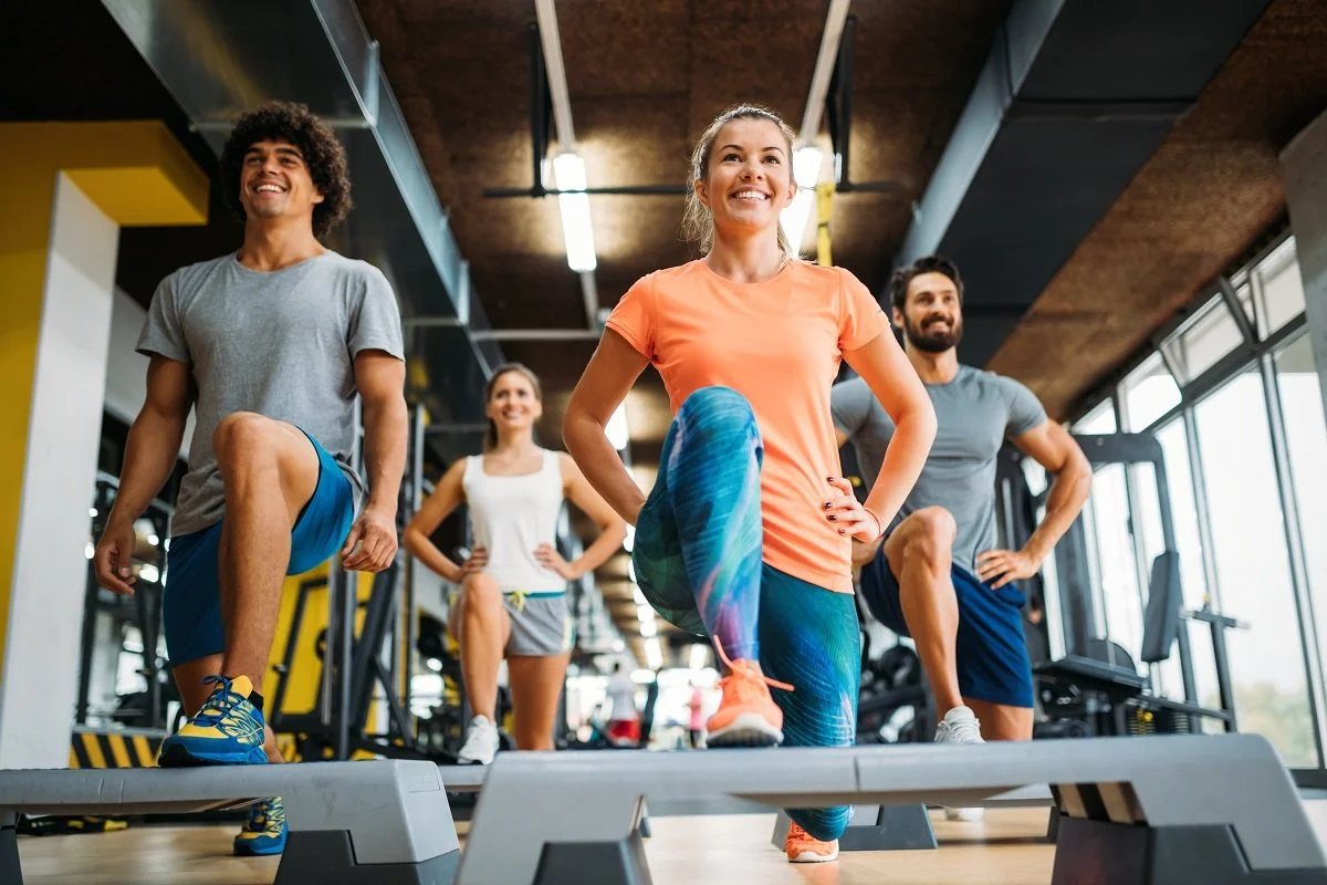 group-of-young-people-doing-exercises-in-gym-PBUL4QT-lr.jpg