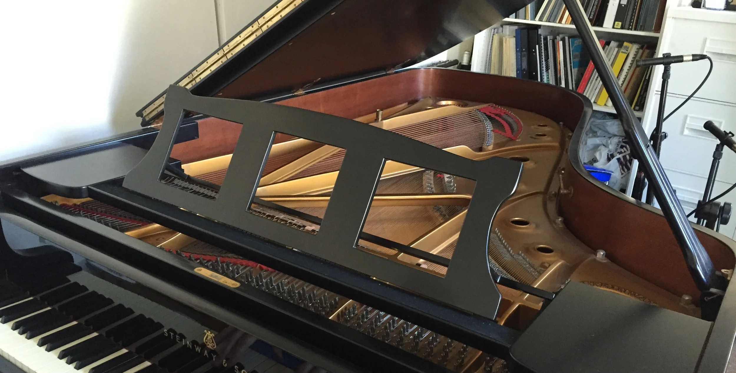 We make custom music desks (such as the one above) for your piano. The advantage is that the square holes allow the sound to be better projected without removing the desk; it makes a big difference to the pianist's impression of tone compared to using a standard solid desk, which tends to act as a sound screen. The original desk is always kept (for re-fitting) in case you sell your piano.