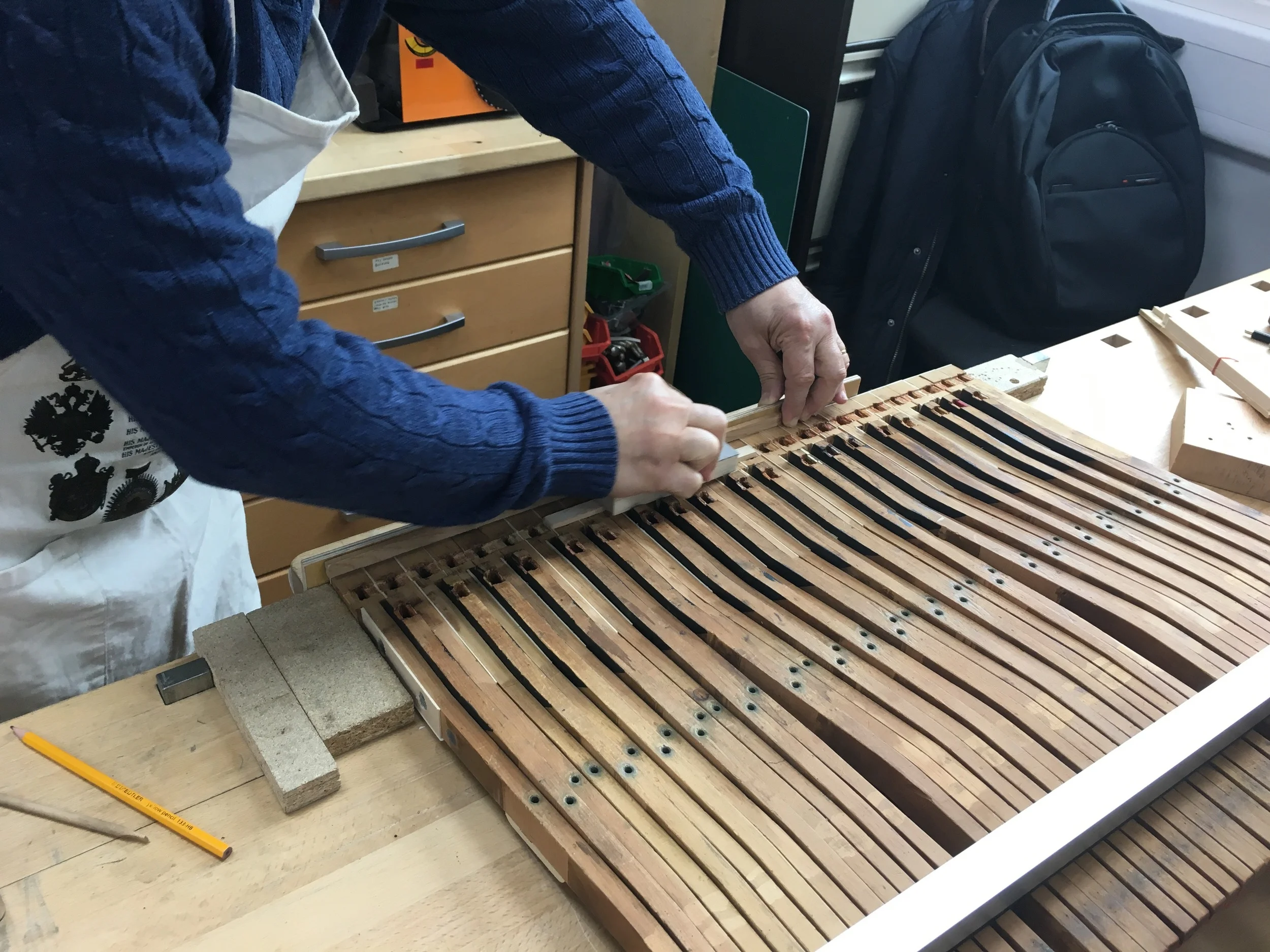 These old, worn keys are being repaired by hollowing out and inserting new wood