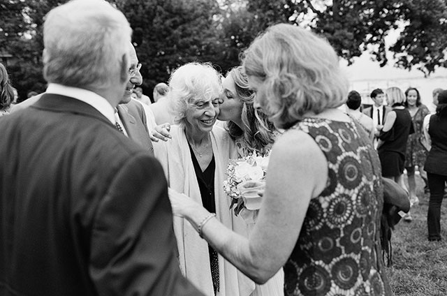 candid cocktail hour photos of couple with guests