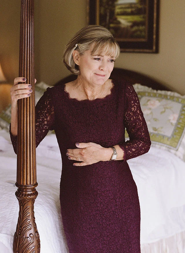 mom looks lovingly at bride in dress