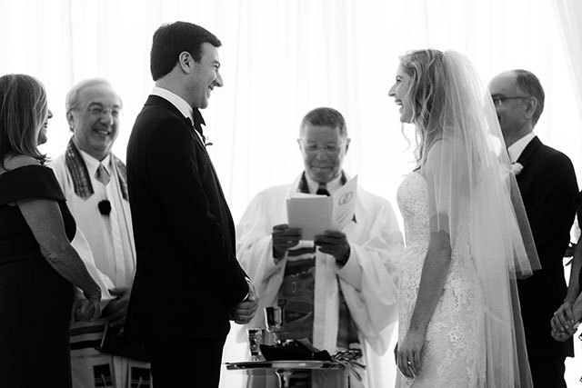 bride and groom laughing during wedding ceremony
