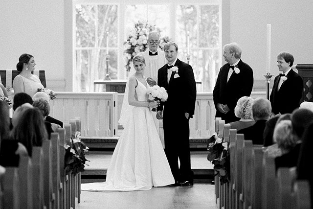 bride and groom look at guests