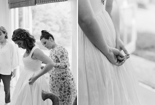 black and white MF film photo of bride putting on wedding dress - Sarah Der Photography