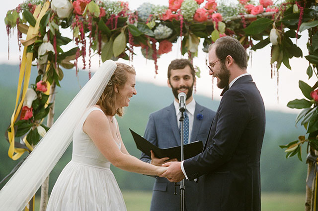 couple laughs as friend talks